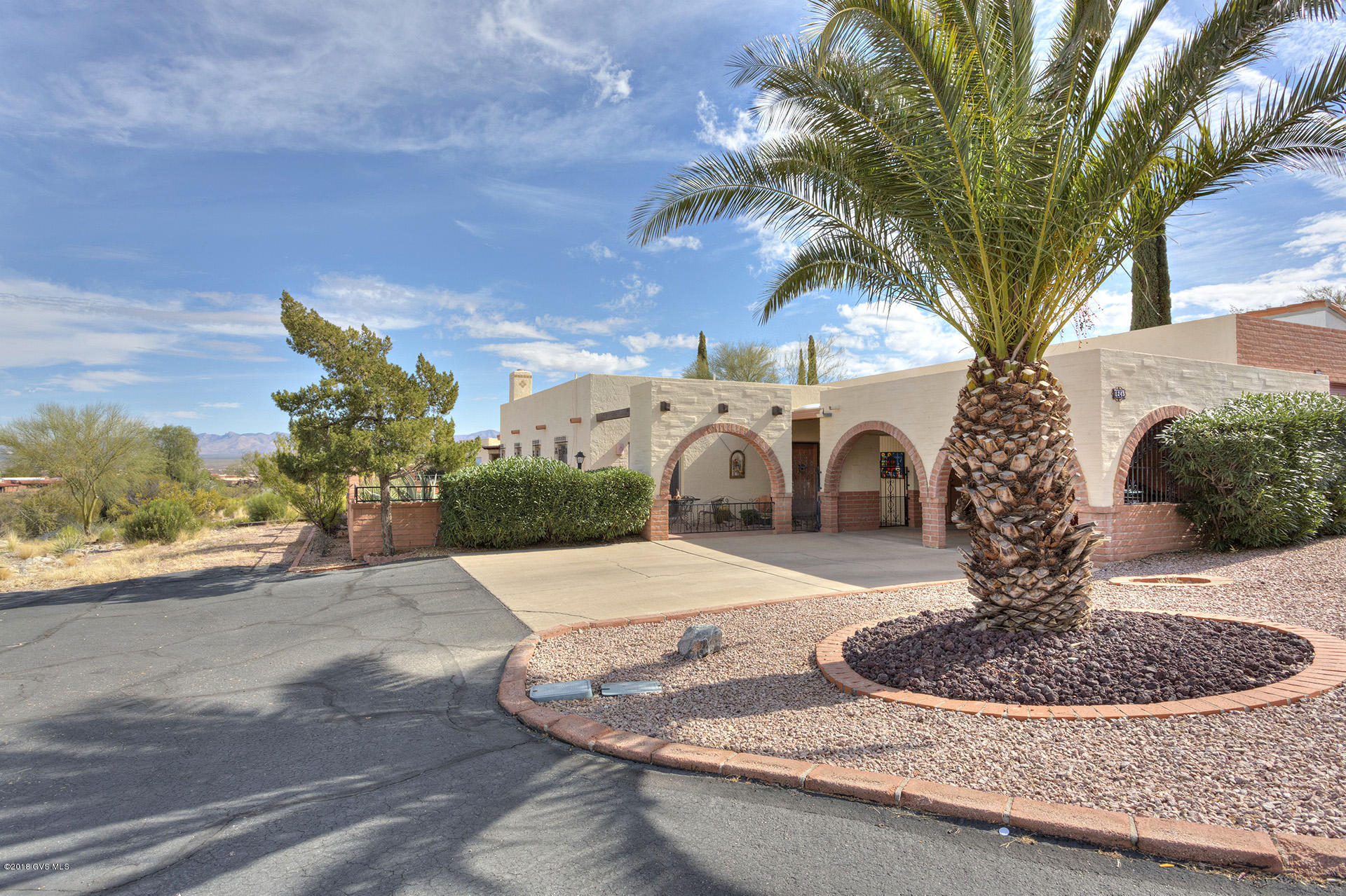 EXPANDED LAGUNA MODEL 2/2 TOWNHOUSE ON ONE OF LARGEST LOTS IN DH2. GREAT VIEWS OVERLOOKING DRIVING RANGE WITH MOUNTAINS IN THE DISTANCE. LOCATED AT END OF STREET, UNIT OFFERS LOTS OF PRIVACY. WINDOWS & SLIDERS ON 3 SIDES OPEN ONTO WRAPAROUND PATIOS WITH WORRY FREE PLANTINGS. ENCLOSED YARD HAS BRICK & WROUGHT IRON HALF-WALL. GATED, PARTIALLY COVERED COURTYARD WITH FOUNTAIN FOR ENTERTAINING OR ENJOYING THE SUN. ENLARGED GREAT ROOM HAS BEEHIVE FIREPLACE. AN ALCOVE ADDED TO MASTER CAN BE USED AS STUDIO, OFFICE OR SITTING ROOM. MAINTENANCE-FREE MOCK SALTILLO TILE IN LIVING AREAS. A REMODELED KITCHEN, PLANTATION SHUTTERS, 2 CAR CARPORT ALREADY ENCLOSED ON 3 SIDES WITH 2 STORAGE UNITS & PAVED RV PARKING SPACE. FURNISHED & MOVE-IN READY! WHAT MORE COULD YOU NEED? WALKING DISTANCE TO GOLF & REC CTR