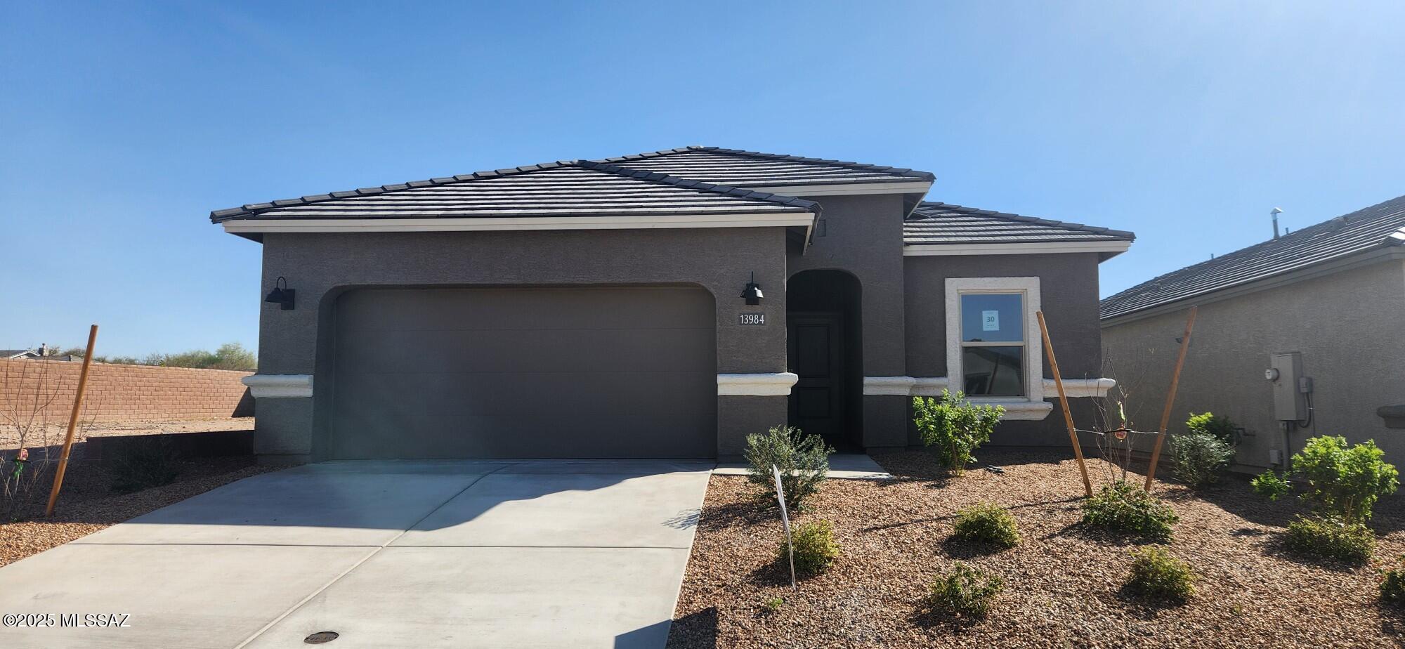 New construction within Rocking K, a master-planned community. This single-story home boasts an array of sophisticated features that cater to comfort and style. This home offers 3 bedrooms and 2 bathrooms across 1423 square feet of living space. The living area is accentuated by 9 feet high ceilings. Quartz countertops in kitchen and bathroom, grey cabinets, and stainless steel appliances including a microwave, dishwasher and gas range. The primary suite has a large closet for ample storage and an en-suite bathroom with a double vanity. Energy efficiency is at the forefront of this home's design, boasting dual pane low-emissivity windows and ceiling fan prewires to ensure comfort year-round. A 2-car garage provides convenient parking and additional storage space.