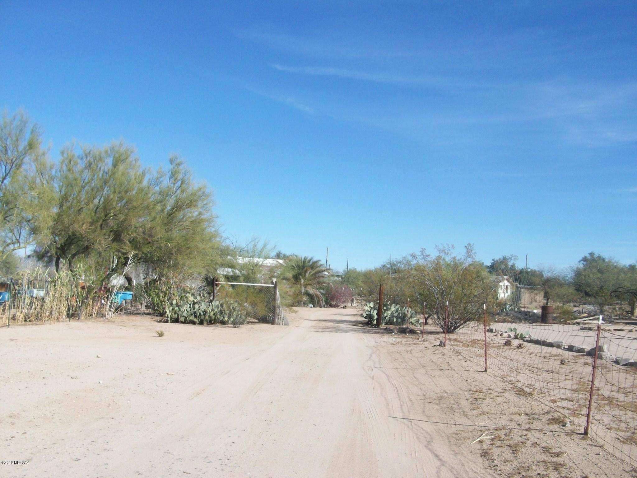 Just under 1 acre in Picture Rocks - property has a trashed mobile (not affixed) and a soon to leave camper tenant. Flat lot - with pole entrance (15') going back to main part of parcel - septic, water and electric on the property.