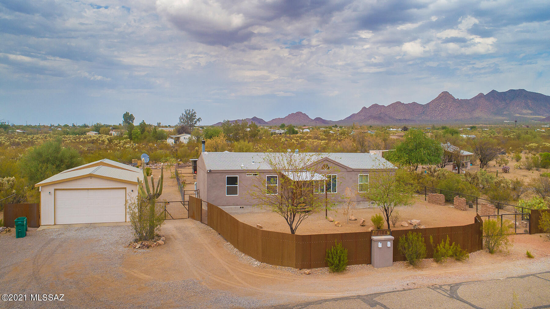 This charming country home features a split floor plan with two spacious living areas. Vaulted ceilings lined with wood make it feel open and welcoming to all who enter. Outside there is plenty of space for pets or even livestock if you wish. An oversized garage has space for your vehicles, toys, and a workshop. The East facing back porch offers views of the Tucson Mountains. Come see it today and make it yours!