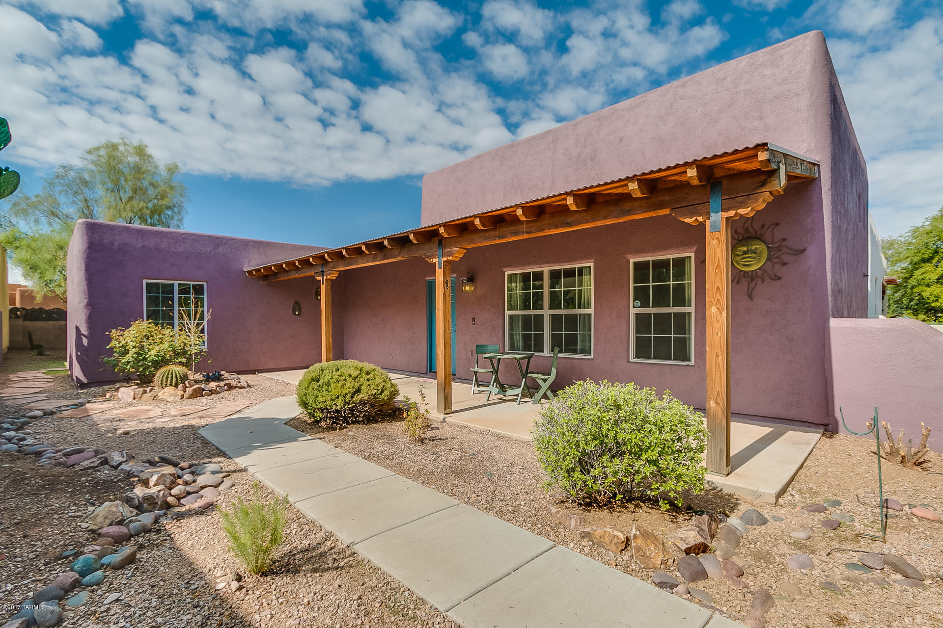 Wonderful one-story home in beautiful Civano neighborhood just one block from Civano Nursery. Civano is a state of the art green housing community located in Southeast Tucson. This north facing home features 3 bedrooms, 2 baths, tile flooring throughout, detached 2-car garage, custom interior paint and beautiful soaring wood beam ceilings in the great room! Outside, this home features a desert oasis - low maintenance front and back yard complete with covered patios, flagstone pathways, mature mesquites and custom artesian ironwork on front and back patio walls - perfect for entertaining! From the moment you walk through the arched entrance to the front courtyard, you will feel at home! This is an amazing home with very positive energy, in a  great neighborhood!!
