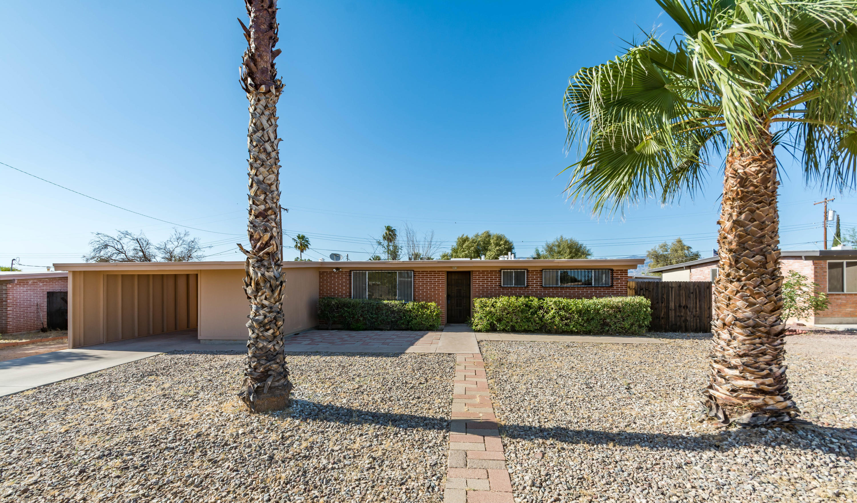 Beautiful single-story home with 3 bed 2 baths. The property is in a great east side location!  This home features all neutral interior palette, a vast open floor plan, natural lighting and new ceramic tile flooring. Both bathrooms include stylish upgraded fixtures, an over sized laundry area which has plenty of extra storage and a spacious kitchen open to a lovely dining area. The roomy and bright living area contains a large sliding glass door that opens to an impressive backyard.   A large covered patio and lush trees provides a great entertaining area. The separate storage shed in the yard provides ample amount of room for seasonal decoration to gardening stuff.  With a back yard of this size you have plenty of room to make it into your own desert oasis!