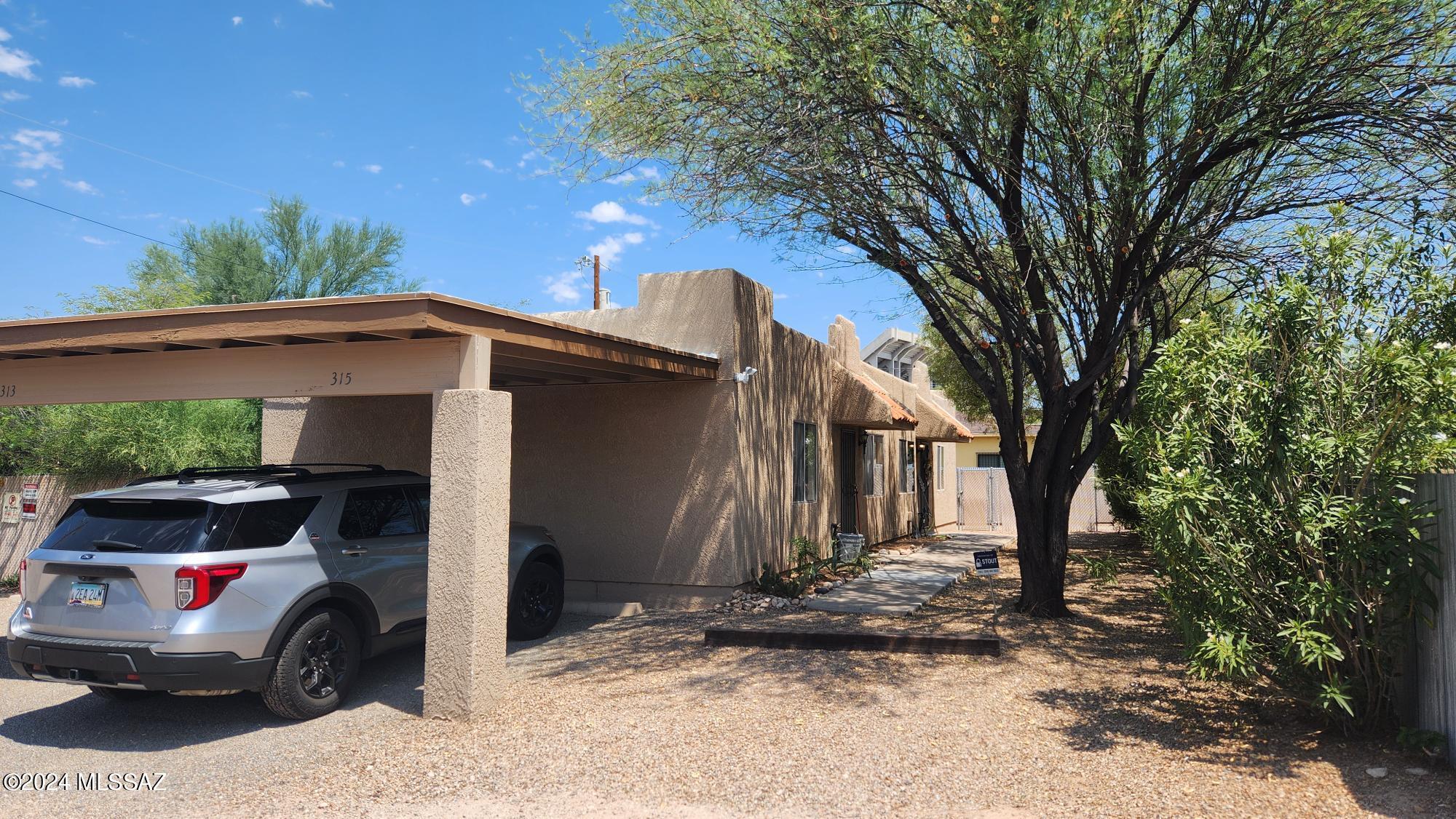 Prime U of A location! Only 2 blocks south of the U of A football stadium. Well maintained and updated 2BR/1BA unit with beautiful ceramic tile floors, central AC and gas heating, living room w/cozy fireplace, covered patio, laundry/storage room, large fenced yard, carport, updated bathroom, updated dual pane windows, updated ceiling fans. Water, trash and sewer included.