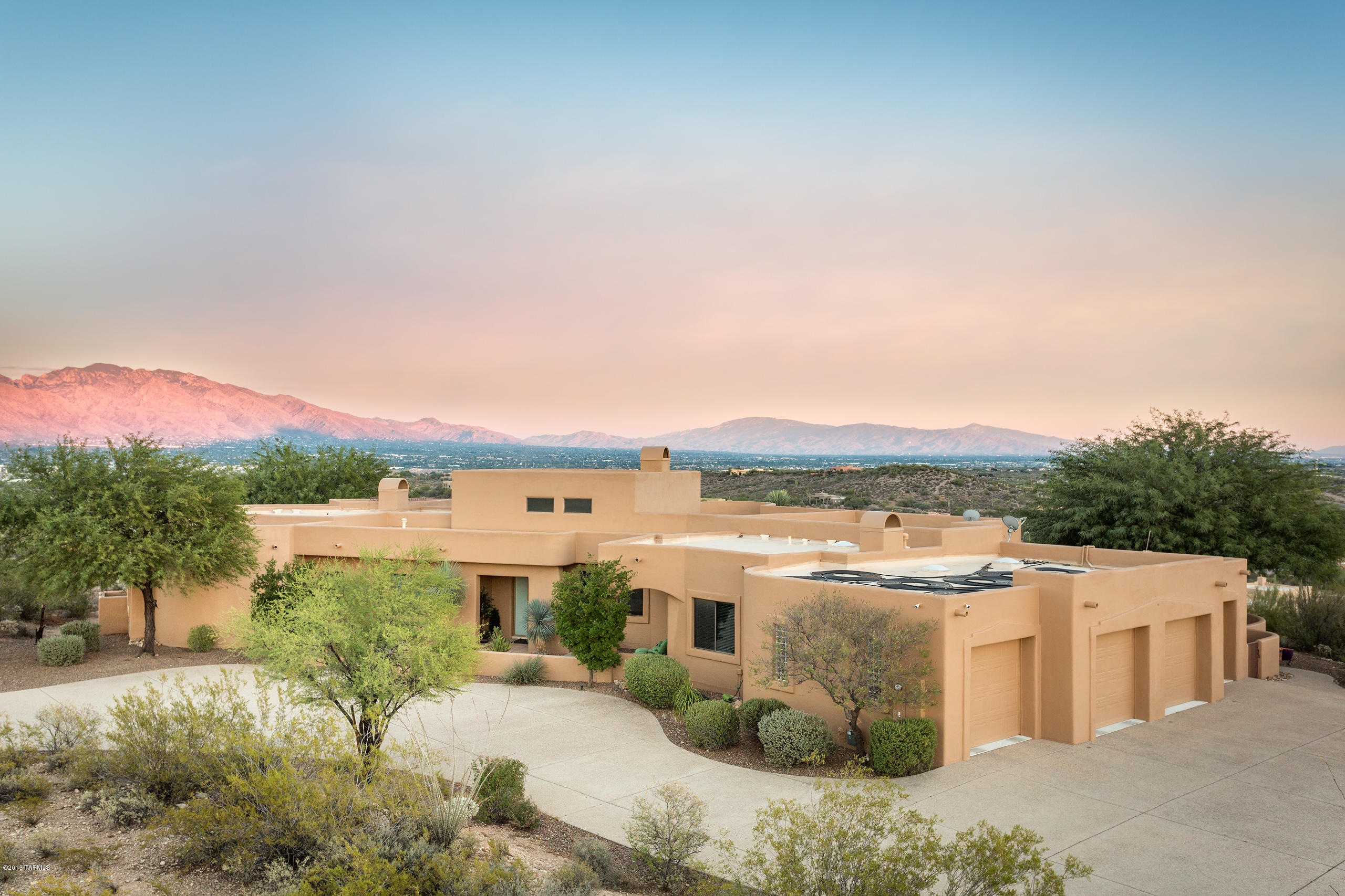 TAR AND KWSA TOUR WINNER FOR LUXURY HOME TOUR 2016
A MUST SEE TODAY!
This is a true gem both architecturally  and aesthetically.  Graceful lines distinguish the beautifully crafted home with windows showcasing the incredible views of the mountains, valley and city lights. This custom built home boasts 3 bedrooms, 3 full baths, music room, media room, office, and 4 car garage.  Over 3 acres on a high elevation, abutting The Saguaro Natl Park, this homesite features the ultimate in desert landscape and breathtaking views.  The interior of this distinguished home is comprised of the finest details and finishes: from the custom cabinets to the trey ceilings with recessed lighting.  The casual elegance of the patio, pool and spa lend themselves equally to tranquil relaxation and grand enterta Awesome 4 car Garage/Workshop with build in Custom cabinets and workbench.  Also Master Bedroom Closet has a direct Laundry room access with a Built in Ironing board.  All of the rooms in the home are very well thought. Built in Grill in back yard for an amazing entertaining space.
