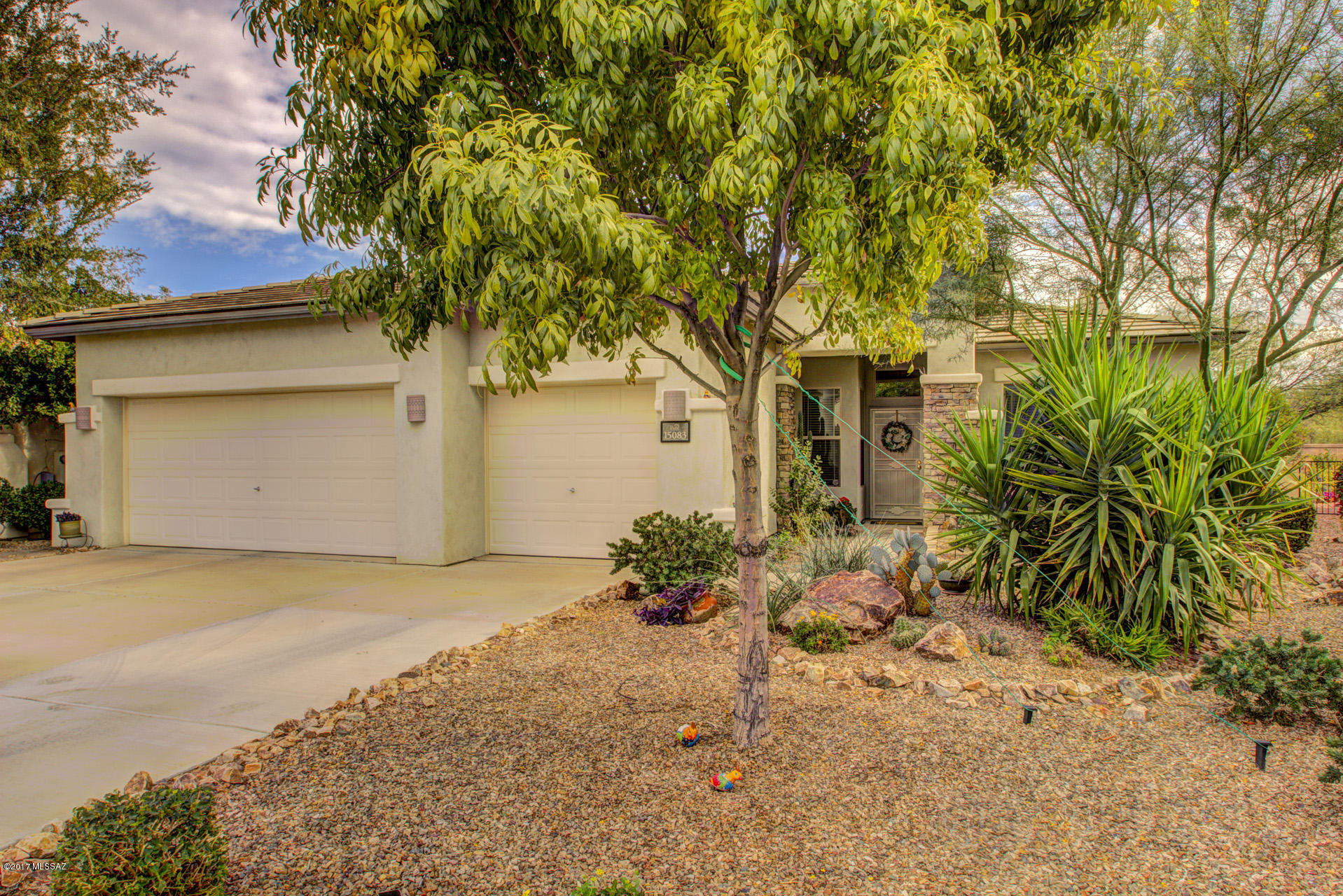 This beautiful former model home built by Pulte in a sought out subdivision "Presidio de la Madera" is walking distance to the Sahuarita lake. This 3BD/2BA single story home on a cul-de-sac with a 3-car garage, stalked stone front curb appeal & no rear neighbors, welcomes with a formal/dining living room adjacent to an open concept family room & kitchen. Family room features a honeycomb fireplace, built in entertainment center & large windows with views to the backyard. Kitchen features Corian counter tops, SS appliances, pendant lights, cherry oak cabinets with pull out drawers, center island/breakfast bar & a breakfast eating area. Double door entry to a bedroom with easy access to a hallway full bath with a shower/tub. Master suite features bay windows, crown molding, a walk in closet with shelves, walk in shower, garden tub & dual vanities. Private laundry room with built in cabinets & access to the garage. Relax outdoors in a covered patio with a pebble tech pool with a waterfall feature, mature vegetation & sitting area. Detailed architectural arches, high ceilings, tile & carpet throughout home plus easy to one of many walking & jogging trails.