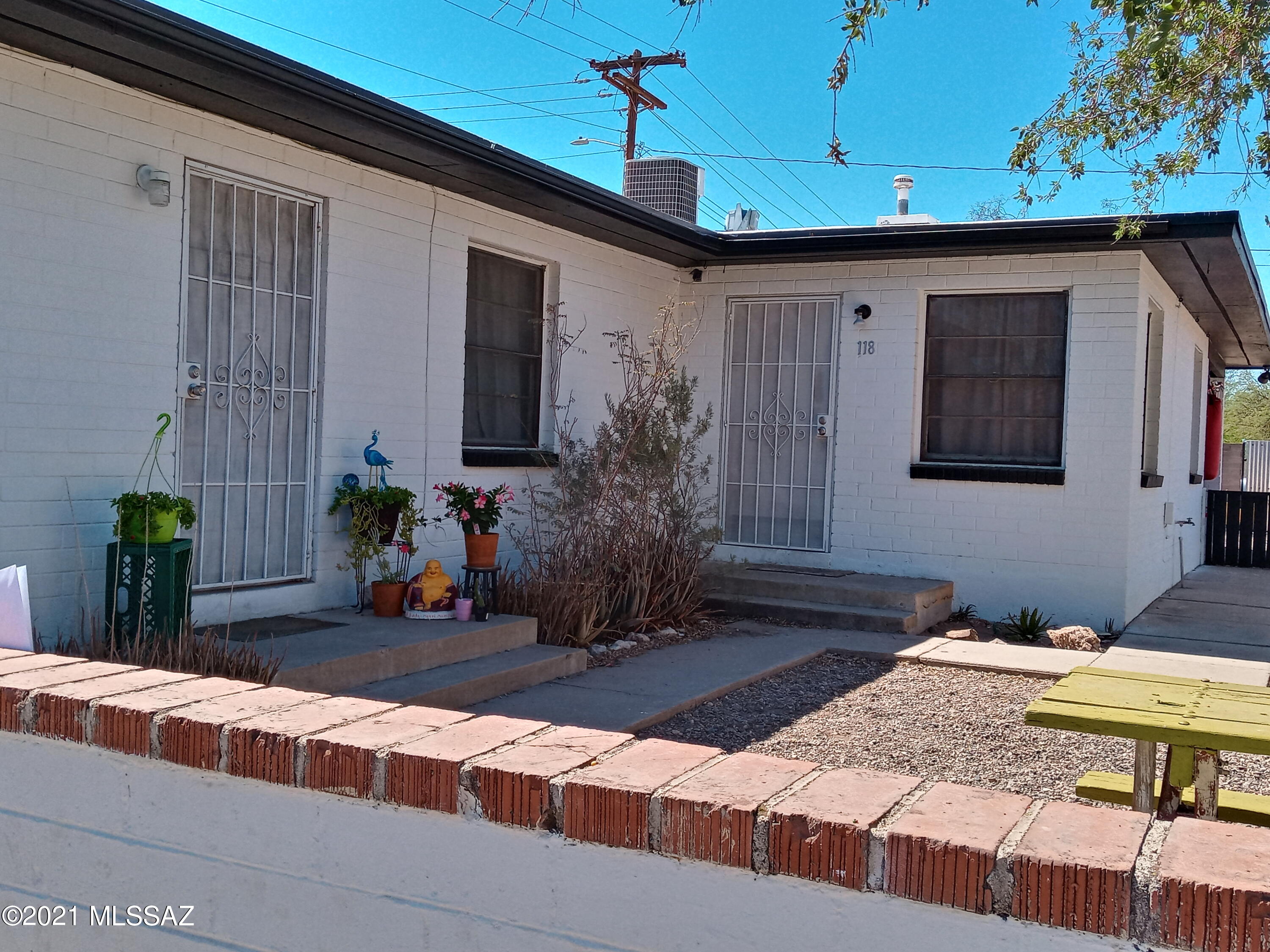 Best Buy in the area!  Especially well built (slump block) Duplex in the W. University Historic district. Beautiful, block wall all around.  Extra large, carport faces Speedway buffers units to the rear of substantial lot.  3 additional parking spaces.   3BR/1BA unit w/ceramic tile floors, large laundry room, covered porch and spacious backyard.  1BR/1BA unit w/finished concrete floors, private laundry & cute front yard.   Newer heating/ac units on both 2019/2020.   All appliances convey with sale.  Exterior recently painted.  Main roof well maintained. New carport roof 2021. Walk/bike/ride within minutes to U of A, PCC, University, 4th Ave and downtown entertainment districts.  118 and 120 postal add.