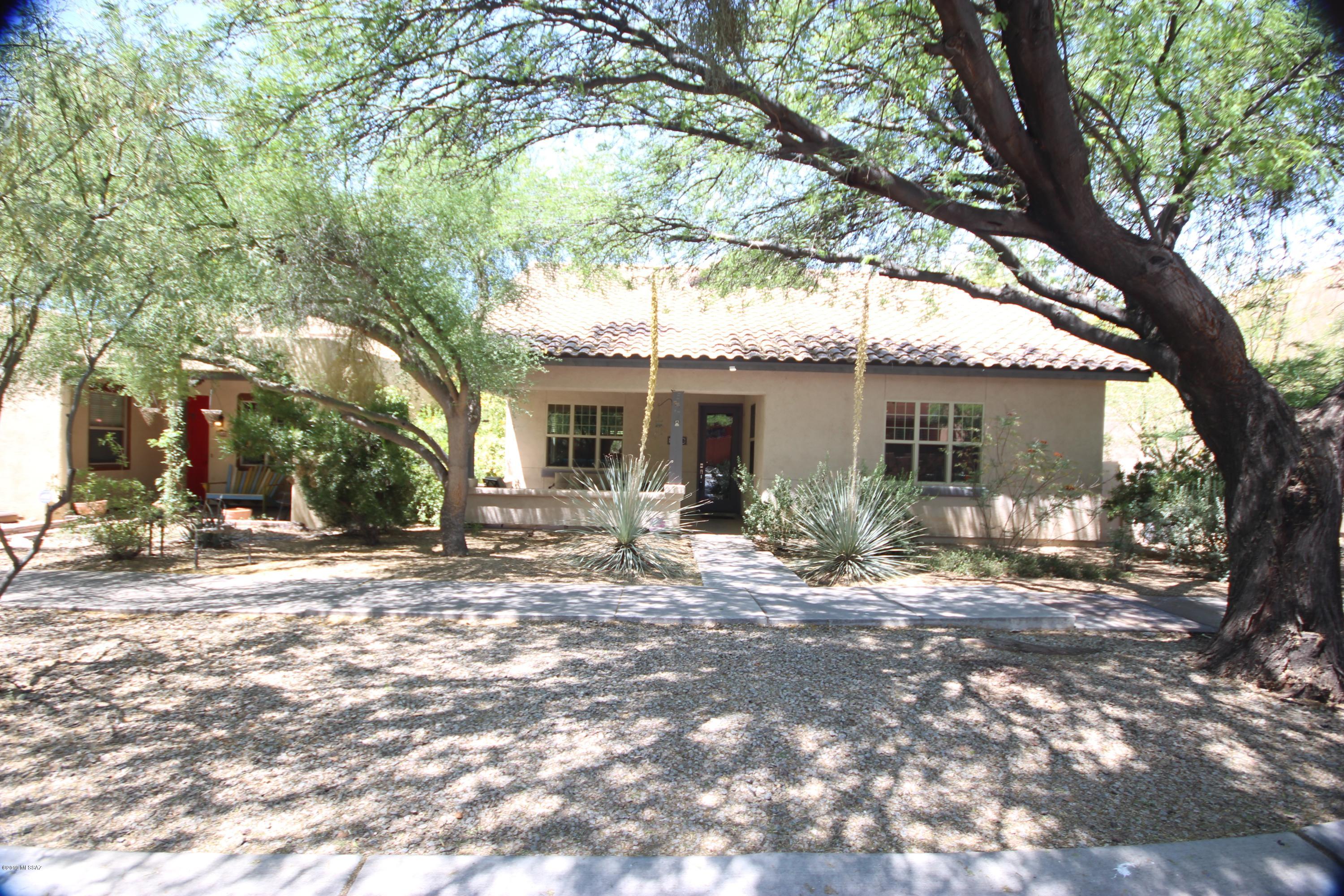 Amazing family home in lovely Civano offers something for everyone. Large living area featuring beautiful wood flooring; massive kitchen with tile counters, newer appliances, work station, breakfast bar and more. Split bedroom plan for utmost privacy. Two bedrooms share access to guest bath with one designed as en suite. Large master has custom walk in closet, full bath and access to patio via French door. Three separate outdoor patios for your pleasure. Ample fenced yard for kids and critters plus a 3-car garage. Solar water heater stays. The community of Civano offers pools, park, soccer field, community garden, half basketball court, walking trail, rec center and more.