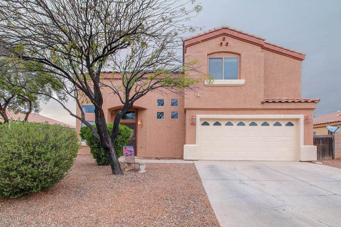 Lovely home located minutes from Casino Del Sol, Old Tucson Studios and the Arizona -Sonora Desert Museum features spacious living room with high ceilings, dining room off kitchen and cozy family room on the first floor with ceramic tile and wood laminate flooring throughout. Second floor landing overlooks the living room area and features 4 bedrooms and conveniently located laundry room.  Master bedroom suite offers large walk-in closet and master bath with dual sinks and separate shower and garden tub.  Covered patio and conventional pool with spa makes the backyard great for entertaining or relaxing.  Additional features include storage shed in backyard, playground set, solar energy system, new pool filter and heater and freshly painted exterior.
