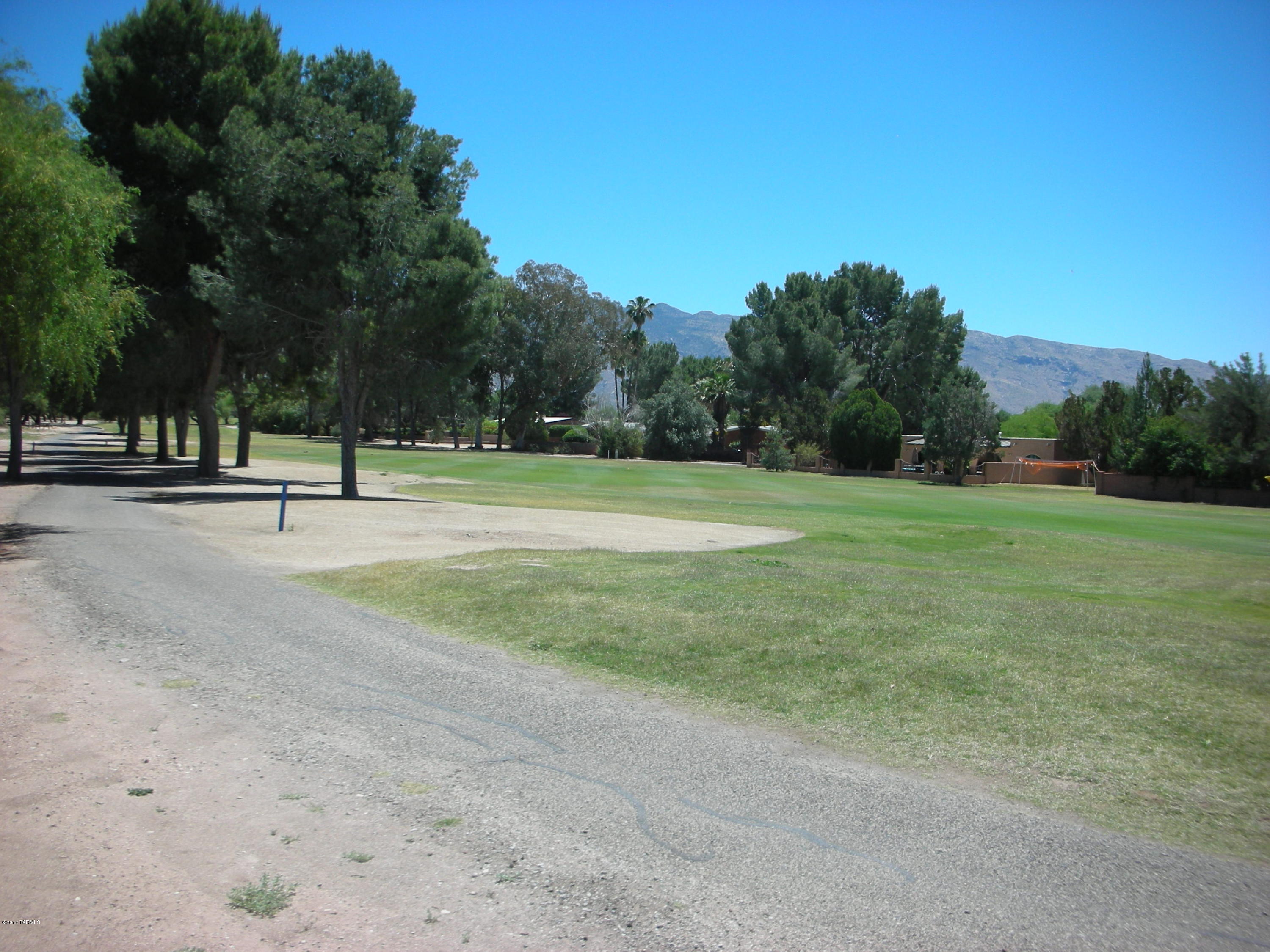 The ONLY GOLF COURSE LOT in TUCSON at this PRICE! Your backyard is the BEAUTIFUL and LUSH 11TH FAIRWAY of this UPDATED and POPULAR, NORTHEAST side GOLF COURSE COMMUNITY. Beautifully MAINTAINED, enjoy Tucson's ORIGINAL, WOODED, COUNTRY CLUB setting where you can still WALK the COURSE. MOUNTAIN VIEWS from the front of your home on this North/South oriented site. Surrounding homes are built. Walk to the Rincon Mountain Grill with all day service. AWARD WINNING Tanque Verde Schools and easy access to all of Tucson make this a SPECIAL OFFERING.