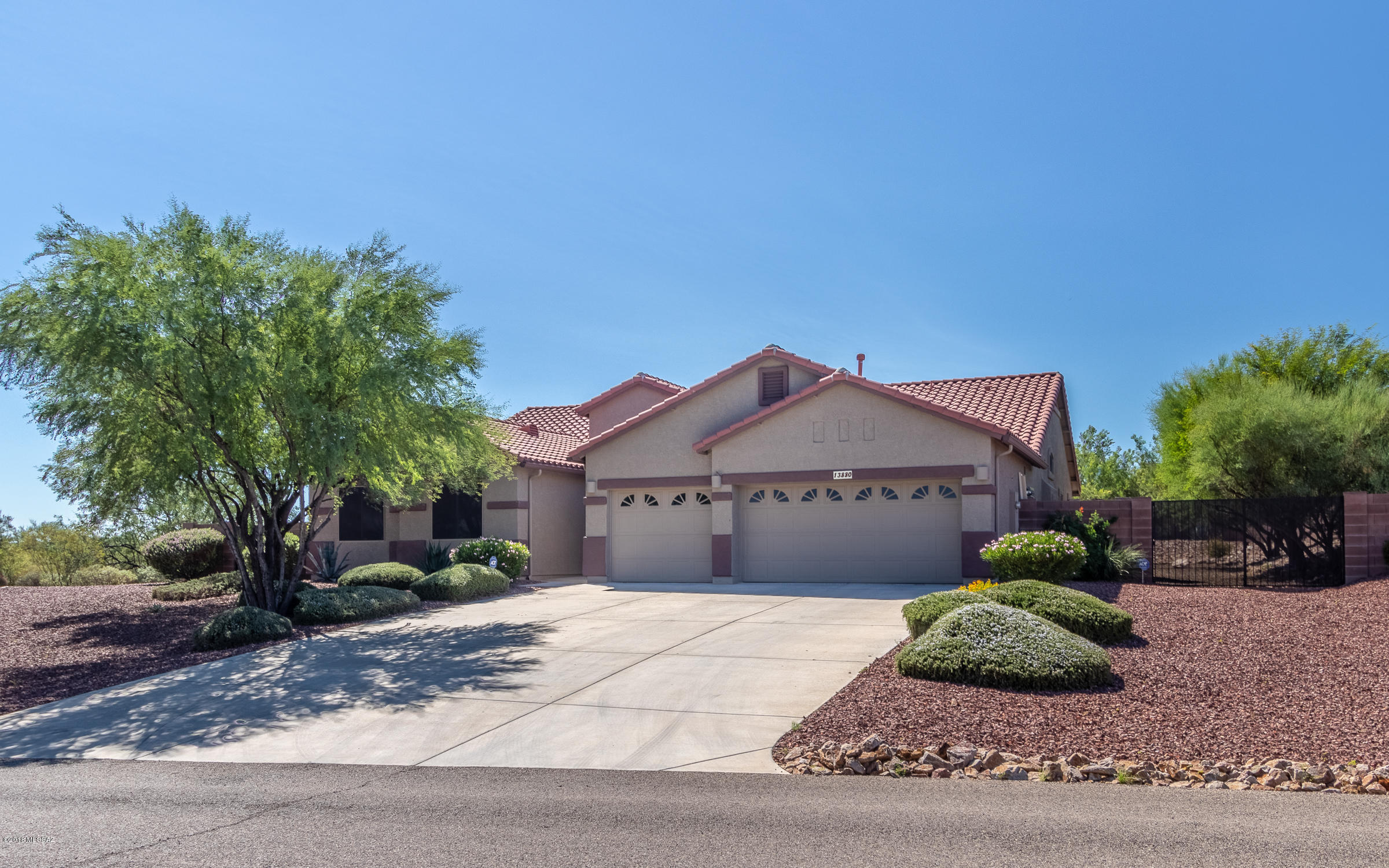 GORGEOUS! This family home is nestled in the much sought after Vail School District. Step thru the custom-built decorative double doors into a perfect 3,085 sf open floor plan w/soaring ceilings, gracious arched entryway & large windows to take in the view! This stunning home offers 5BR/ 3 full baths, a formal living/dining room & huge family room. The gourmet  kitchen features center island, extra cabinets, stainless steel appliances, walk-in pantry, & porcelain tile w/decorative borders. Washer/ Dryer conveys. Direct Vent Fireplace. Extra tile in Master Bath/Closet & kitchen¬area hallway. Two inch wood blinds, extra storage throughout & 3-car garage. Security doors on all entrances. New Paint & carpet. Newer Dual Zone AC/Furnace. Gutters. Professional landscaping w/block & wrought iron wall. Drip Irrigation. Storage shed. Fountain. Electrical conduit for Hot Tub. Covered & open patio provides a superb gathering place for everyone to enjoy! The home is also furnished with ceiling fans, a water softener & dusk-to dawn security lighting plus automatic outside garage & walkway lights. Energy features include extra insulation, 2X6 construction & solar screens on windows for year round savings! Situated on 1ac. with panoramic mountain views, what more could you ask for!!