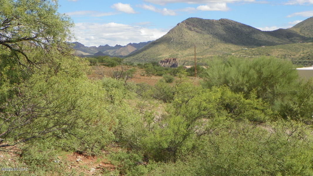 This lot has a beautiful view of the surrounding mountains, front and rear.  It has an electricity pole nearby, water and it is connected to sewer.  Ready to build your next dream home!