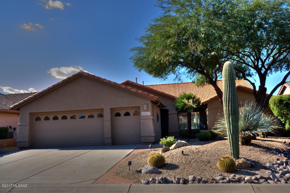 Unobstructed views of the Catalina Mts across open desert space. Open Great room Montana plan with wood floors, high ceiling and a wall of windows to enjoy the views. Well designed kitchen has gas cooking, 2 drawer Fisher & Paykel dishwasher, granite counters, cream white cabinets and a large center island. Warm desert colors throughout plus ceiling fans and some plantation shutters. The den has built-in bookcases and wood floor. The large master suite has a bay window, shower bath and walk-in closet. Outside the brick patio is covered across the back of the house with a built-in gas barbecue, tile serving counter and refrigerator. 4 ft. extended garage plus separate golf cart garage. Located near Club House, restaruants, tennis, fitness, pools, theater and dog park.