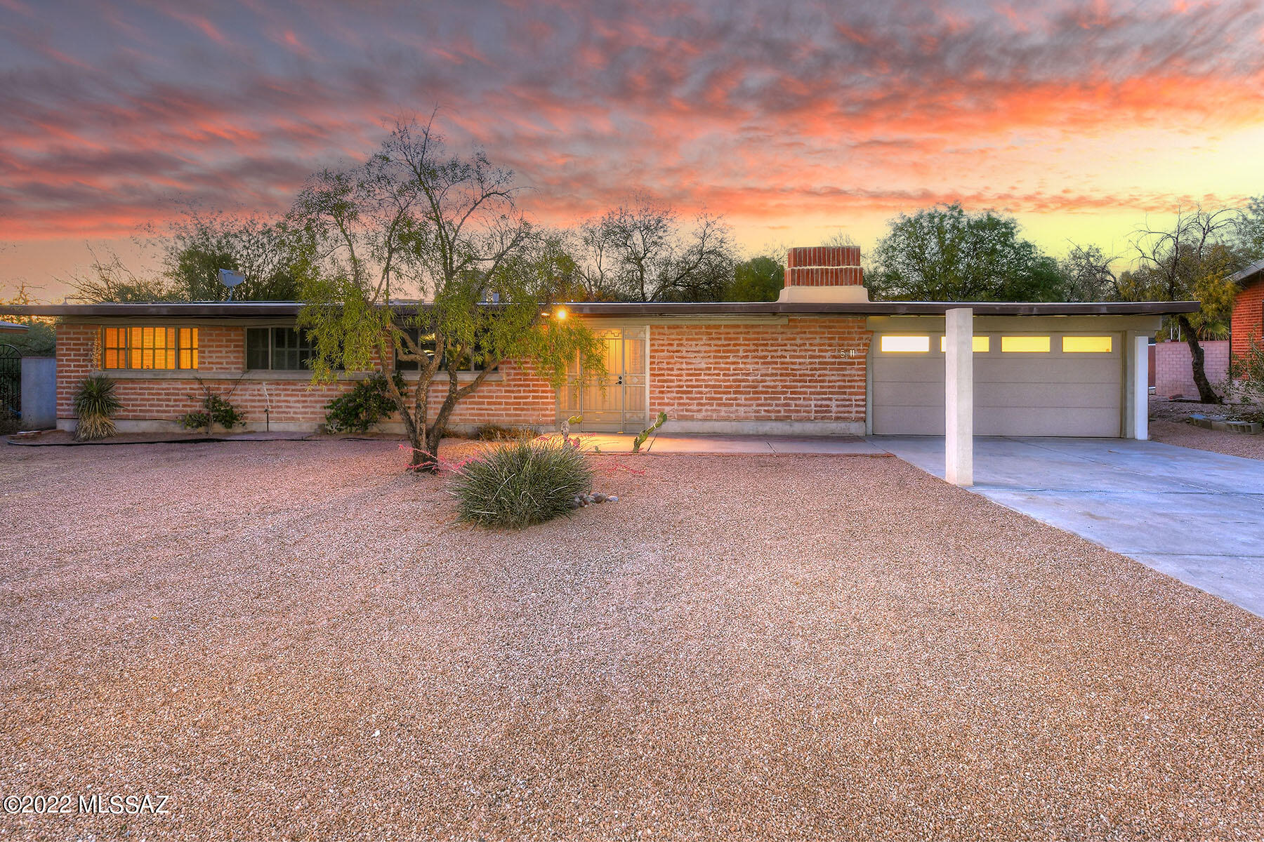 Beautifully restored mid-century modern home, designed and built by Tucson modernist architect Tom Gist in 1963. Consistent with Gist's unique design aesthetic, this home features burnt adobe masonry, concrete sill windows in the front of the house, triangular gable windows on the east and west, and a large, north facing window wall in the back. The newly renovated kitchen includes distinctive, award winning SieMatic cabinetry, custom integrated Miele refrigerator, dishwasher and ovens, a Bosch range with an Elica range hood. Honed concrete floors throughout the home. Kitchen, dining areas and master bedroom face original brick, terraced patios and pool. Two car garage adjacent to covered patio space. Located on a quiet cul-de-sac, convenient to shops, restaurants and entertainment.