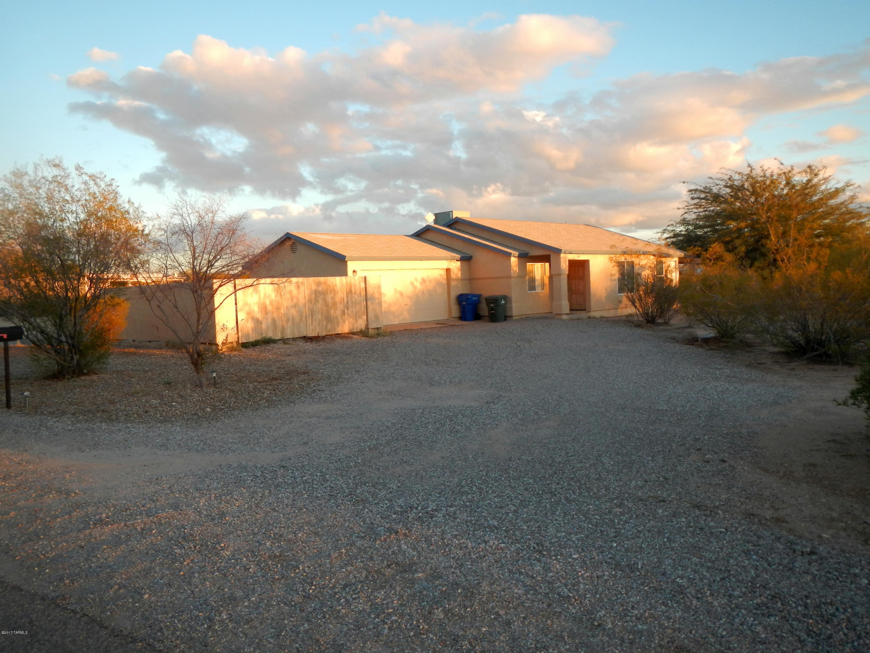 Unique property in Tucson with 3.92 acres to enjoy. Rare acerage with very little restrictions, large fenced in yard with 6' high wall.Extra building with full bath to use how ever you choose shop-studio-storage. 2 additional sheds that are made out of Cement, very unique. 3 bed 2 bath main house with new carpeting. Bring your imagination as to what you would like to do with this property. Close to express way easy access into the property. Very unique property, not many that are almost 4 acres