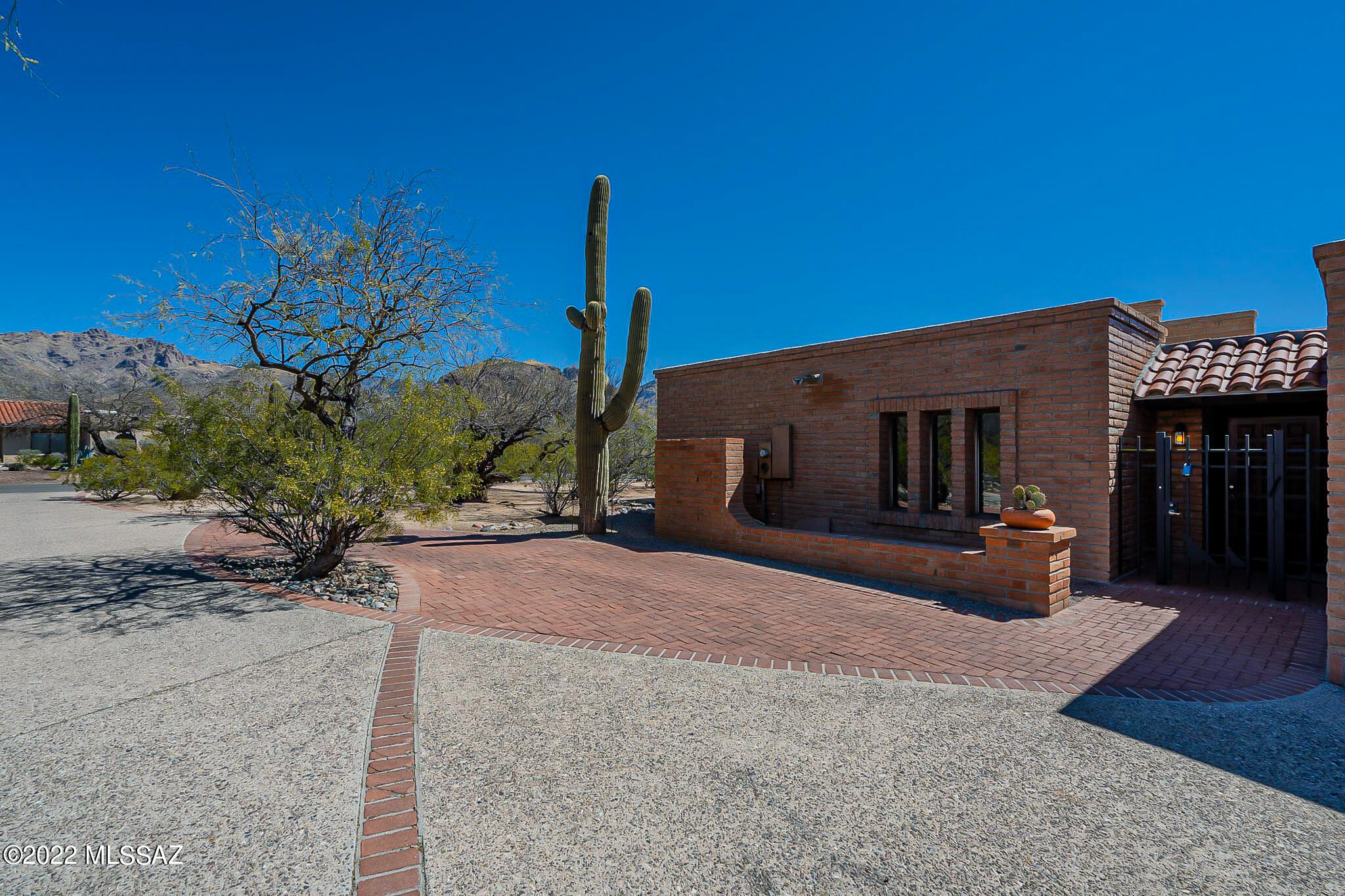 First time ever on the market!  Solid southwestern home within walking distance to Sabino Canyon + gorgeous Catalina Mountain views. This Sasabe Burnt Adobe home was custom made for the current owners. Constructed using double block with an inch of foam between. Anderson/infinity windows on all but 2 windows + two HVAC units replaced in 2019. This is the original green building construction that not only looks great but is warm in the winter and cool in the summer. The craftsmanship, quality and pride of ownership shines through the home. Featuring two unique living spaces, an Arizona rom, three bedrooms and two bath + laundry room. Why buy a flip with low quality materials when all this one needs is some new carpet and paint?
When you visit don't forget to check out storage in the garage