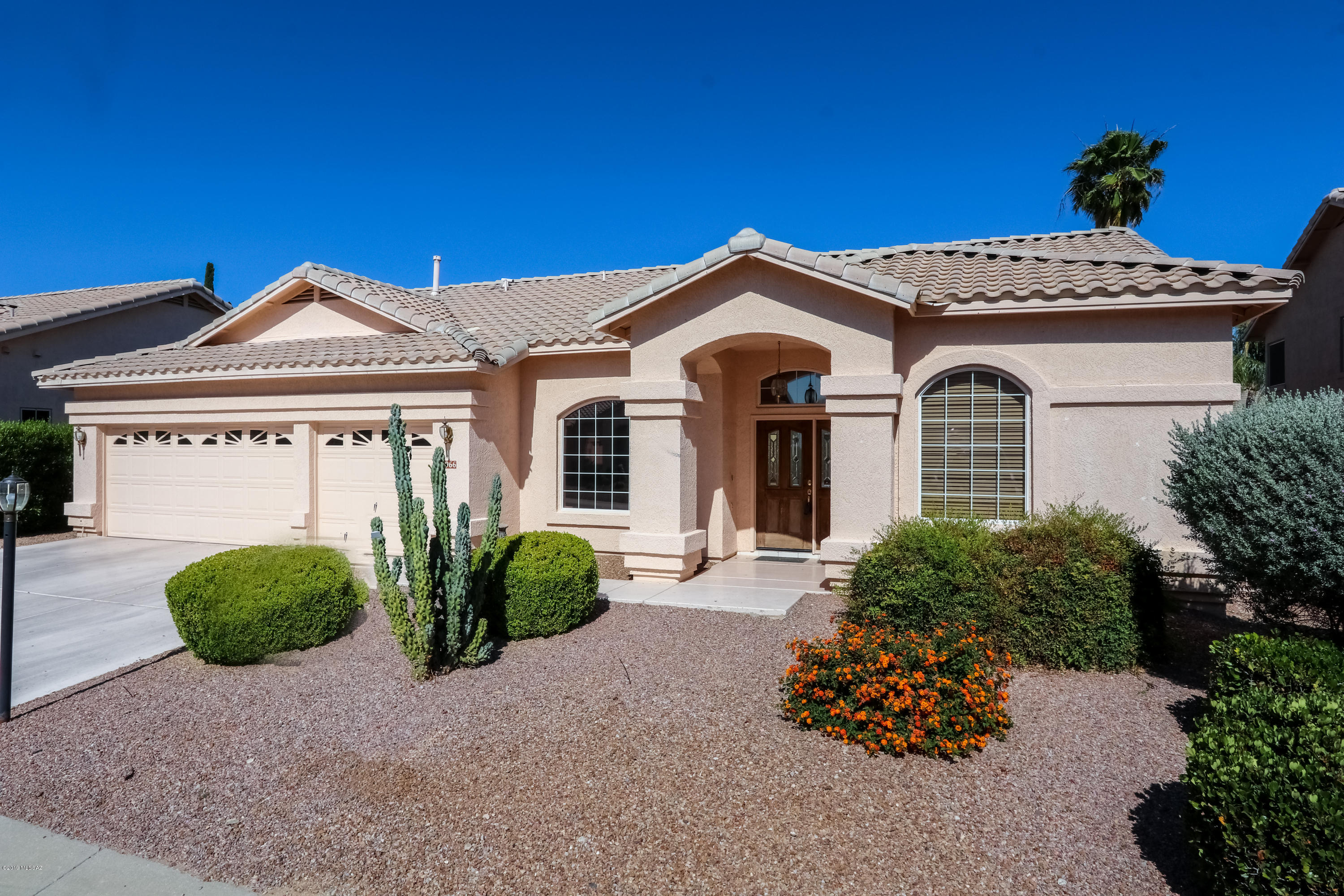 Don't miss this 4 BR split floor plan with quest quarters in sought after Canada Hills in Beautiful Oro Valley. Step into this move in ready home with vaulted ceilings & over sized windows offering mountain views. Open floor plan perfect for entertaining allows the festivities to pour out onto the patio overlooking a  beautiful & private yard with planters, mature vegetation, artificial turf, B.B.  court and inviting pool.  4th BR/guest suite with private bath has a private entrance from house and rear yard.  2.5 car garage has plenty of room for golf cart or motorcycles, etc.  Huge master w/ entrance to rear yard, huge walk-in closet, and master bath with sep. tub & shower! Kitchen is a chef's delight with double ovens, gas range and over sized pantry.