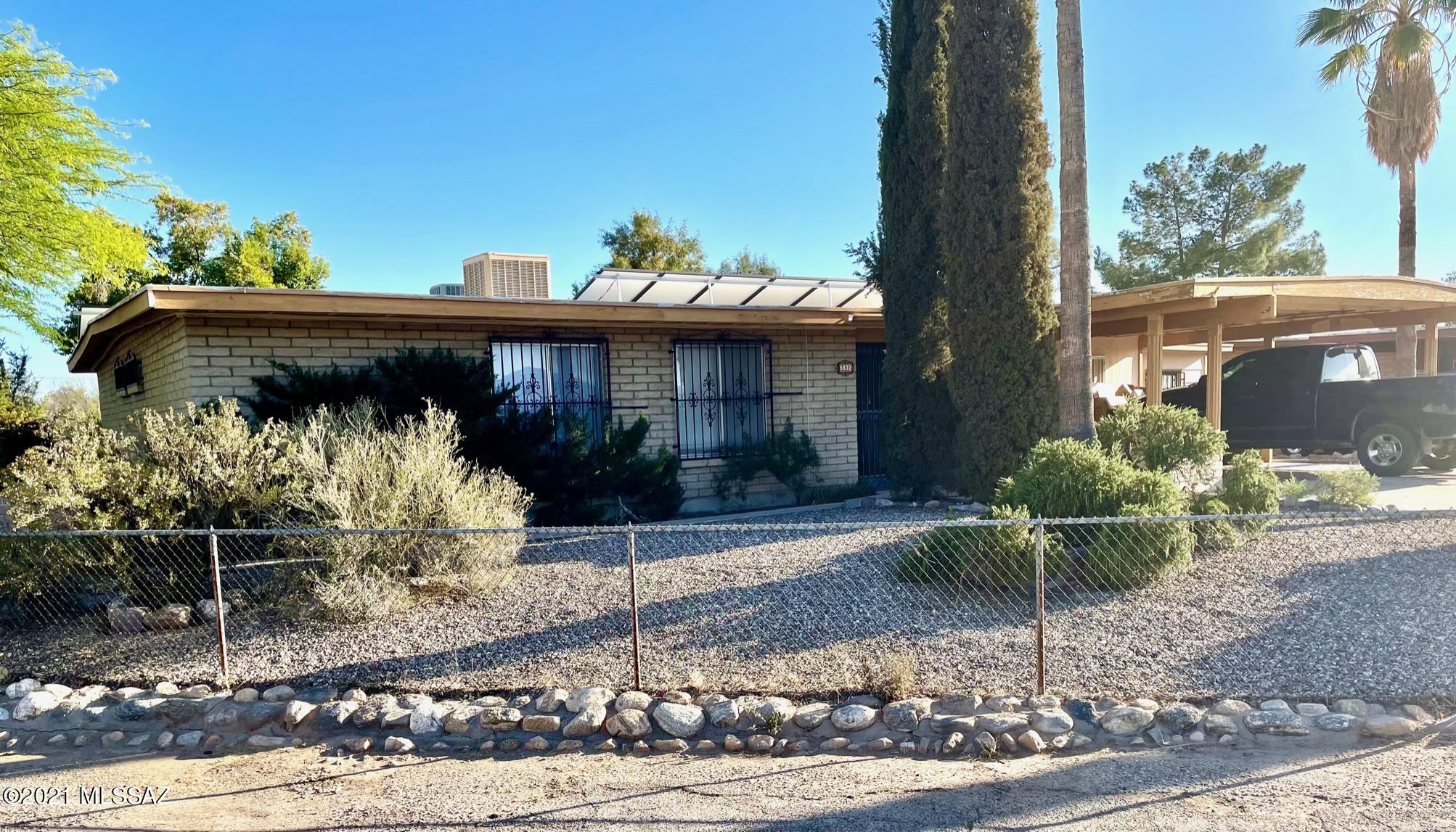 Eastside home on 1/4 acre corner lot with completely owned solar panels! Inside the home you will find good living spaces for different needs, multiple  ceiling fans, security screened front porch area, 60 gallon water tank, wrought iron on the windows and 2 sets of sliding doors to the covered patio from one living area and another from a bedroom. Outside, there are mature shade trees, grass, natural vegetation and areas to put in a garden all with a timed irrigation system. The 8 x 10 Tuff shed has extended eaves, fan, cool coated roof and shelves inside. There is a 13' x 16' attached workshop with carport access. Come see all the possibilities this home has!