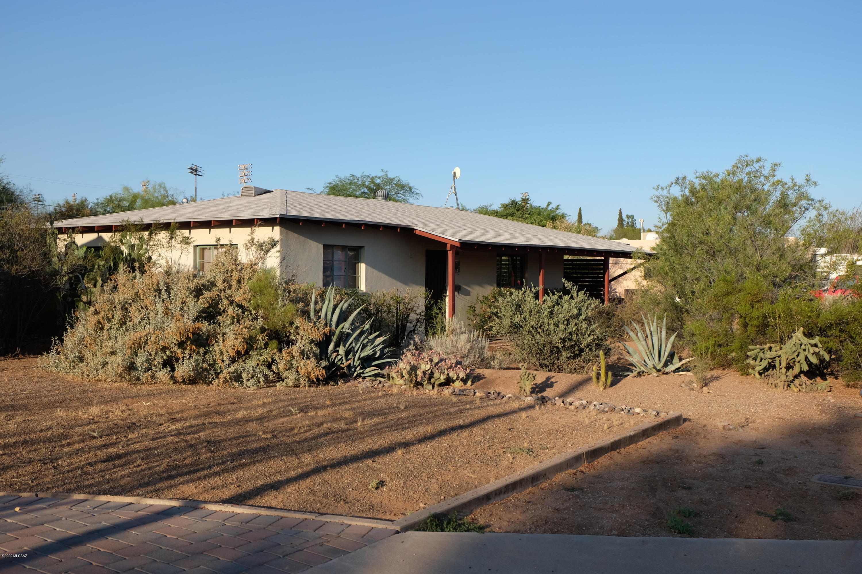 This solid, comfortable 2 bed/1 bath red brick Tucson Bungalow is on a big quarter acre lot, with Sonoran desert inspired front yard, covered front porch, one car carport, stained concrete and tile floors, a spacious living room and an eat in kitchen.  The back yard is huge, with lots of mature desert plantings that are right for our climate, including Saguaros, Palo Verde, Mesquites, as well as a fruit bearing Pomegranate,    plus there's plenty of room for whatever project you might want to do, all in a great central location.  Easy access to downtown Tucson,  University of Arizona.  This one is a gem.