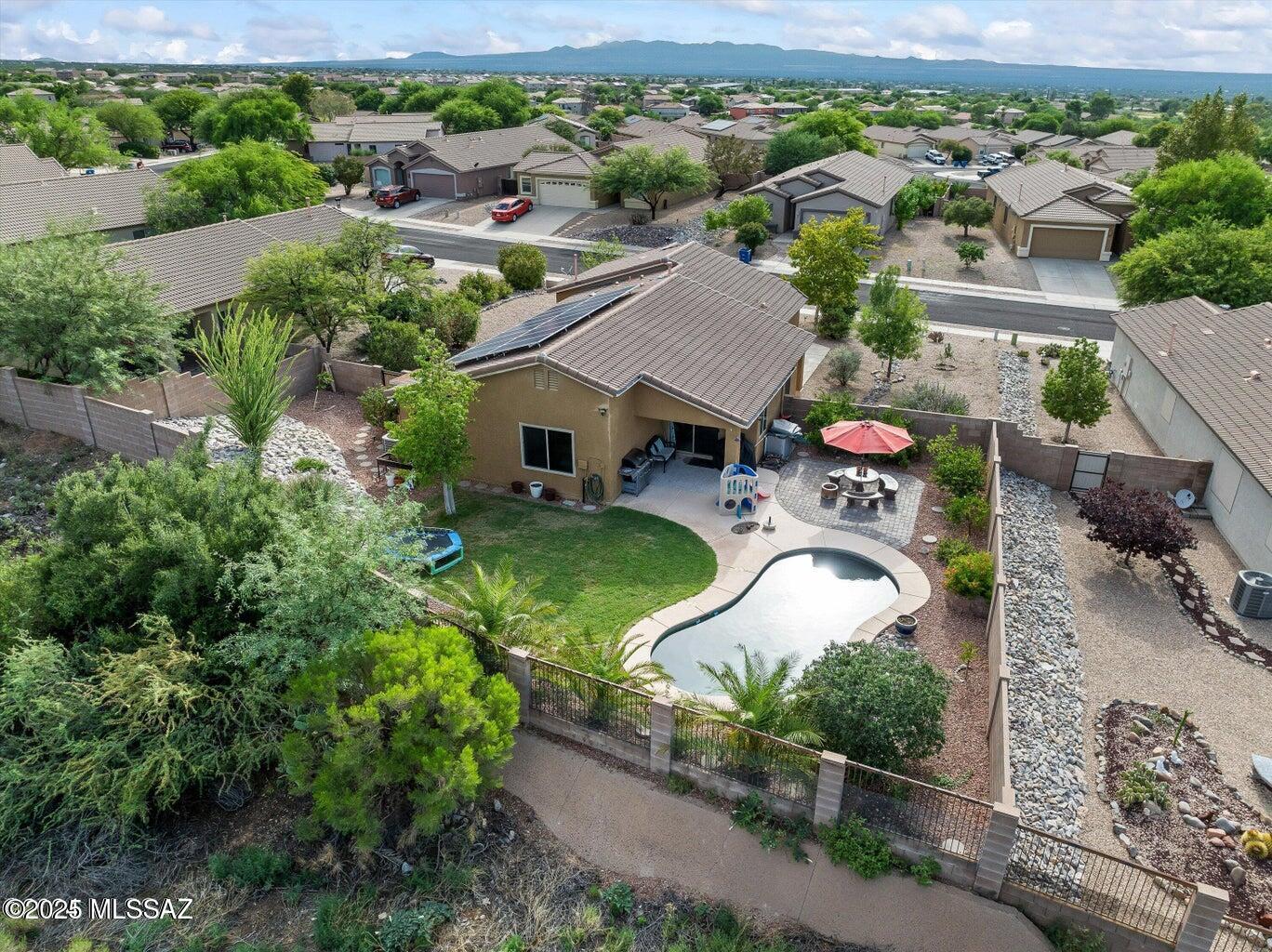 Located in the top-rated Vail School District, this 4 bed, 2 bath home situated on a huge private lot features a popular open floorplan with no carpet (new LVP in all bedrooms), a beautifully updated kitchen, brand new primary shower, and fully owned solar panels reducing your energy bill to almost nothing.  The private backyard is an entertainer's dream with sparkling pebble tech pool, grass, pavers, no rear neighbors, and plenty of space for everyone.  A 2.5 car garage and backyard shed adds extra storage or workspace flexibility.  Sellers are including a home warranty for added peace of mind. This home truly has everything you're looking for!