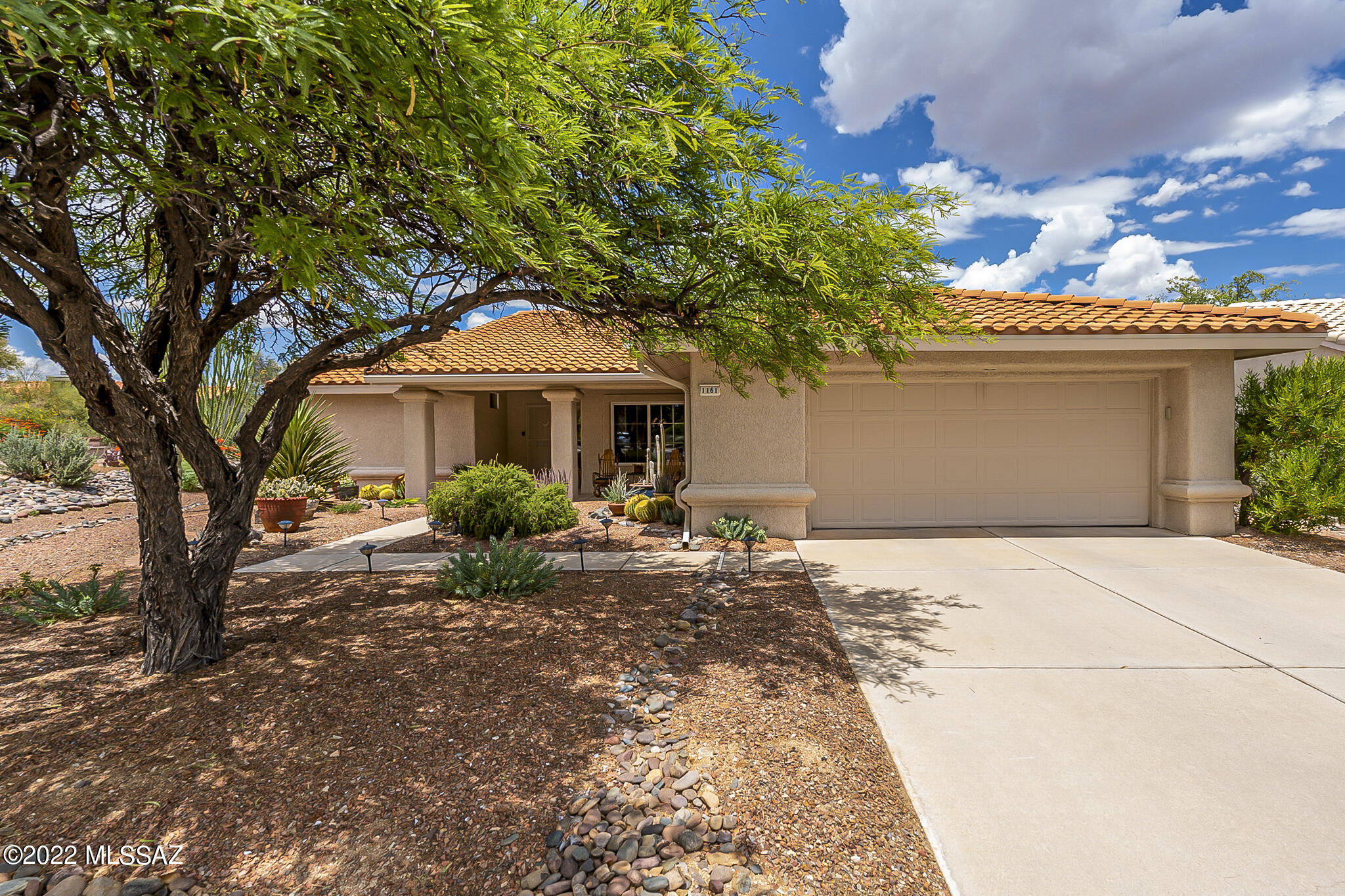 This meticulously  maintained  extended Cottonwood  Model is a must see! This home is 1674 sq feet  with updates.  Featuring 2 bedrooms, 2 baths and tile in  all main areas and carpet in bedrooms.   The cook will  enjoy the large  kitchen with re-faced Hickory cabinets and Quartz  countertops. All appliances convey. The guest  bedroom features a Murphy Bed  with desk. The Owners Suite has bay window, dual sinks in bath and shower  with a large walk-in closet.  Enjoy the N  facing back patio with BBQ grill and low  care landscape. The backyard  is fenced.  See  Features sheet  in documents for  more  details on update.  HVAC-2021,   Roof underlayment 2017. No Drip  system on  home. Call today to view this home  and start enjoying the Sun City Oro Valley lifestyle.