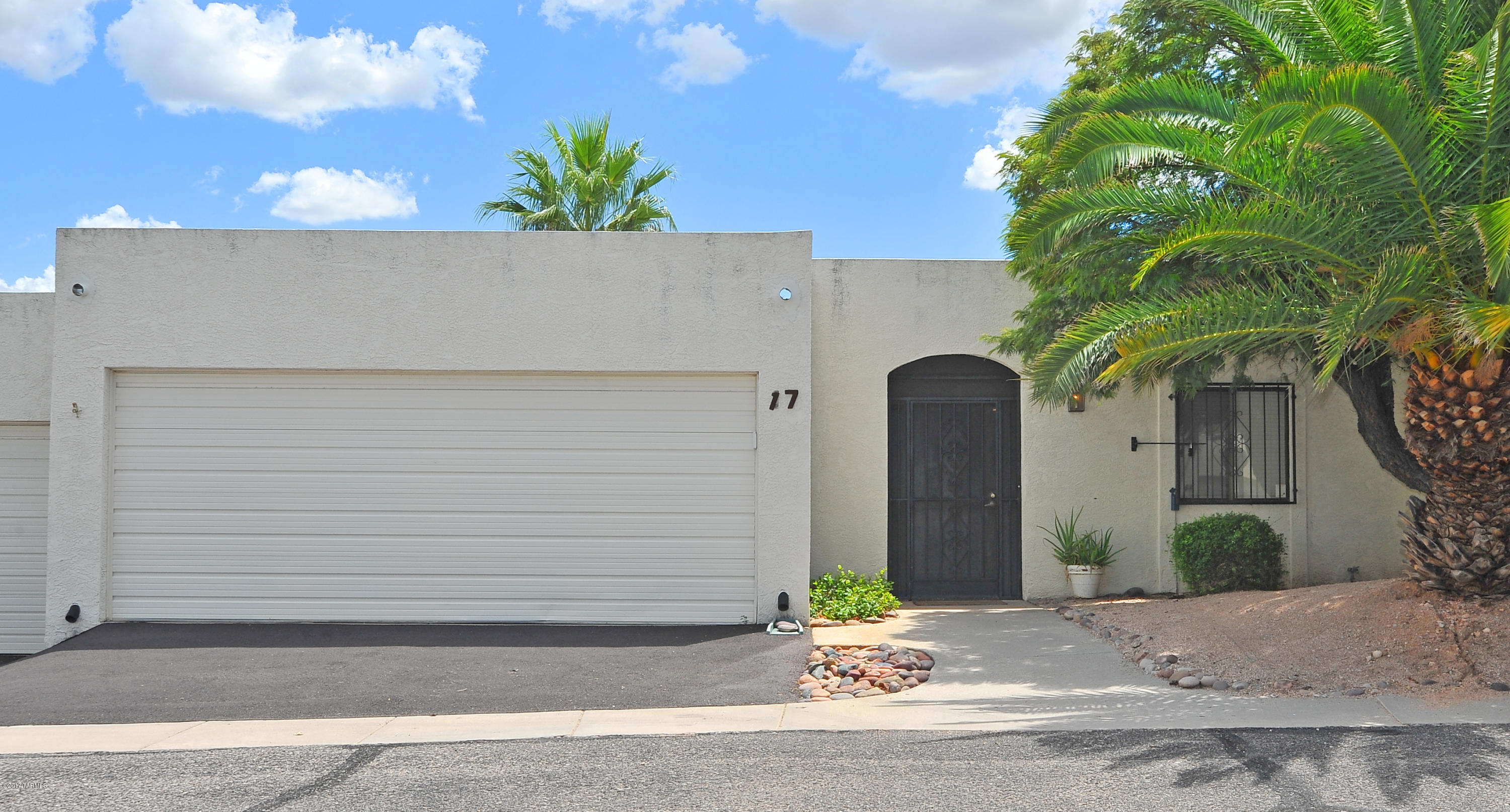 Move in ready! Condo living that feels like a townhome in Harrison Estates. Meticulously cared for home with spacious great room and charming beehive fireplace that opens to dining area.  Split  floor plan with laminate wood flooring, ceramic tile and carpeted bedrooms, Eat in Kitchen, enclosed Arizona Room with storage (room for a desk) and super quiet and tranquil patio facing south with retractable awning. No neighbors behind! New hot water heater, and carpet installed 2016. Short walk to the sparkling pool. HOA takes care of water, common grounds, trash, termite, exterior building and roof maintenance.  Will not last long!