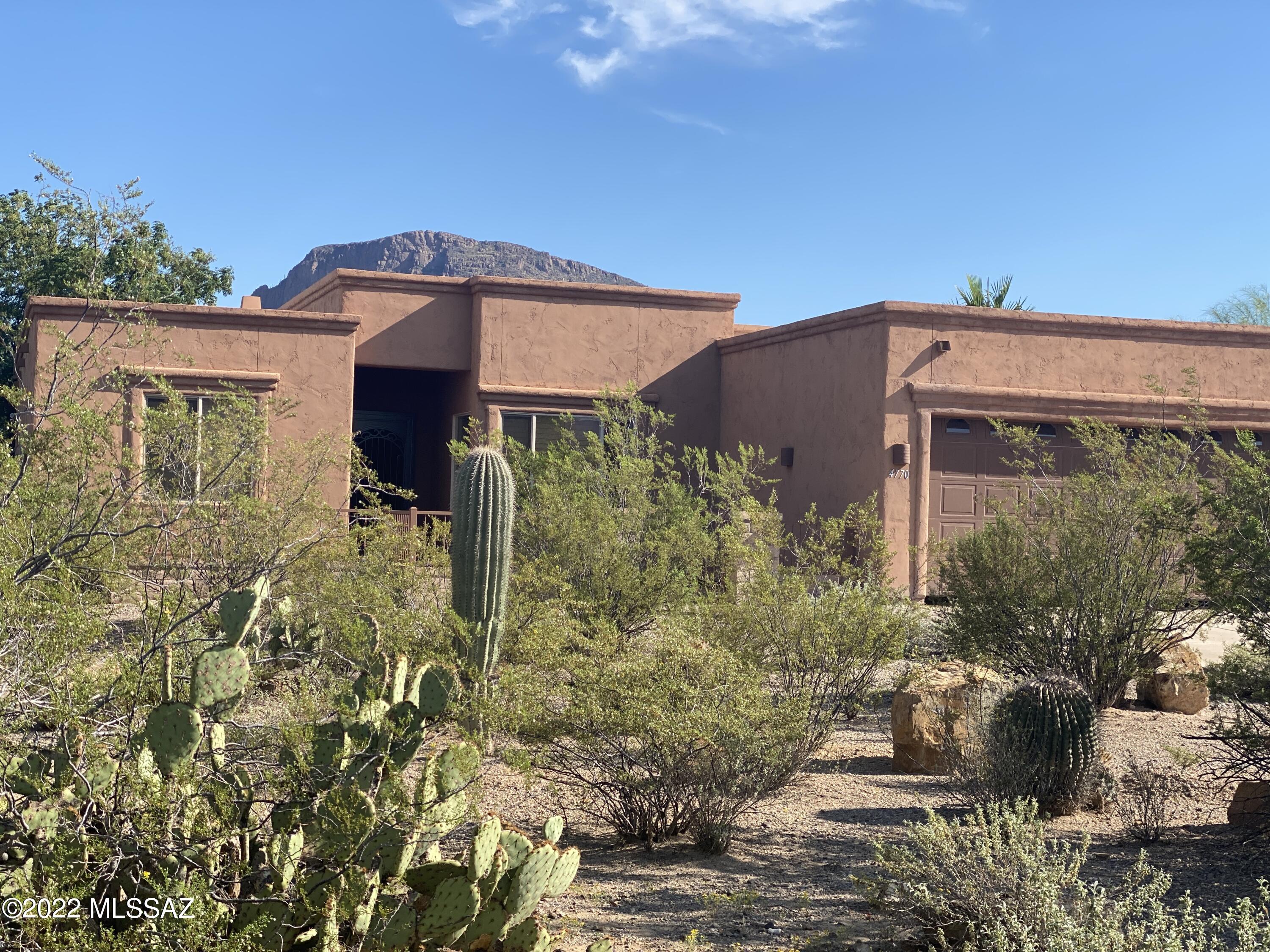 With acceptable offer 10 K credit for  Buyers choice: Upgrades, closing cost, buy down rate.  2 new AC's installed, 3 car garage w/brand new epoxy floors, skylights & extra storage room, 9-11 ft ceilings, 8ft entry door, R38 insulation. Split floor plan: 2 master suites & guest room: 3 bed and 3 full bath! Primary suite has executives dual sinks, 2 separate showers and garden tub. Ceiling fans, Wood shutters and blinds throughout, Carpet in all the bedrooms, tile in all other areas. Chefs kitchen with gas cooktop and electric oven, island with prep sink and sprawling countertops. Enjoy full view of Cat mtn to the north. The back yard is easy care landscape with both gas and wood Grills under a huge Ramada, and covered patio allows for entertaining with privacy(lot extend past the brick wal