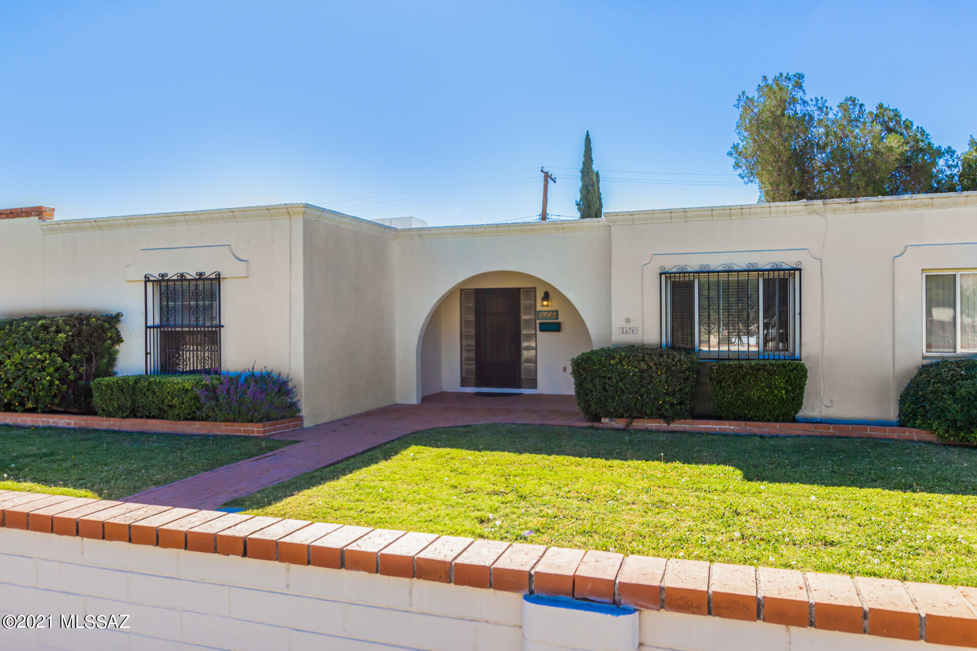 Beautiful 3 bed, 2 bath property w/meticulous front yard, detached 2-car garage with a 3rd private parking pad next to garage is on the market.  Enter through the custom iron door to discover a spacious interior w/fresh soothing palette & new paint, tile floor, carpet in all the right places, new ceiling fans & light fixtures, & access to the back patio from dining area. Newly updated Galley kitchen features a plethora of white cabinets, SS appliances, recessed lighting, & granite counters. Large main bedroom boasts multiple sizable closets, sliding doors leading to the back patio, & a private bathroom. Gather your loved ones in the fabulous backyard w/extended brick patio, citrus trees, & plenty of space to hang out! This is Age Restricted, 55+ only. Book a Showing Today! Great location near parks, shopping spots, restaurants, & so much more! What are you waiting for? Book a tour today