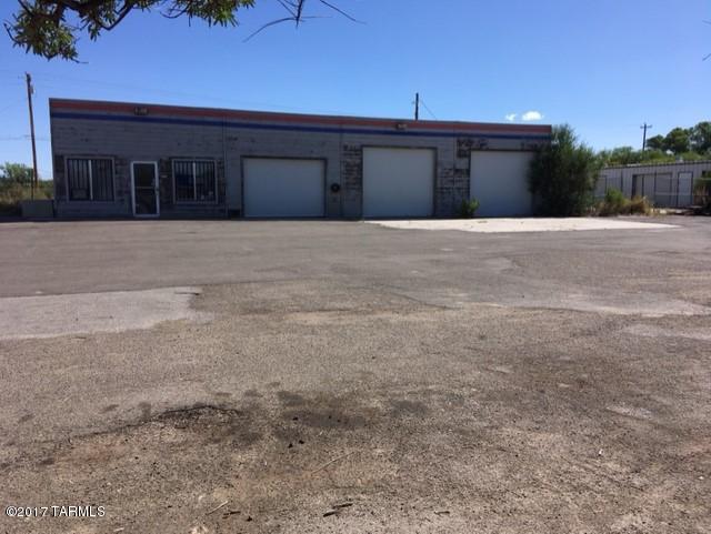 Repair shop with 3 roll up doors and was a fuel station. Fenced yard, extra storage building(tx pcl#123-24-005). Owner cannot supply SPDS, but does have a recent ADEQ report stating it's acceptable condition. All offers must have proof of funds.