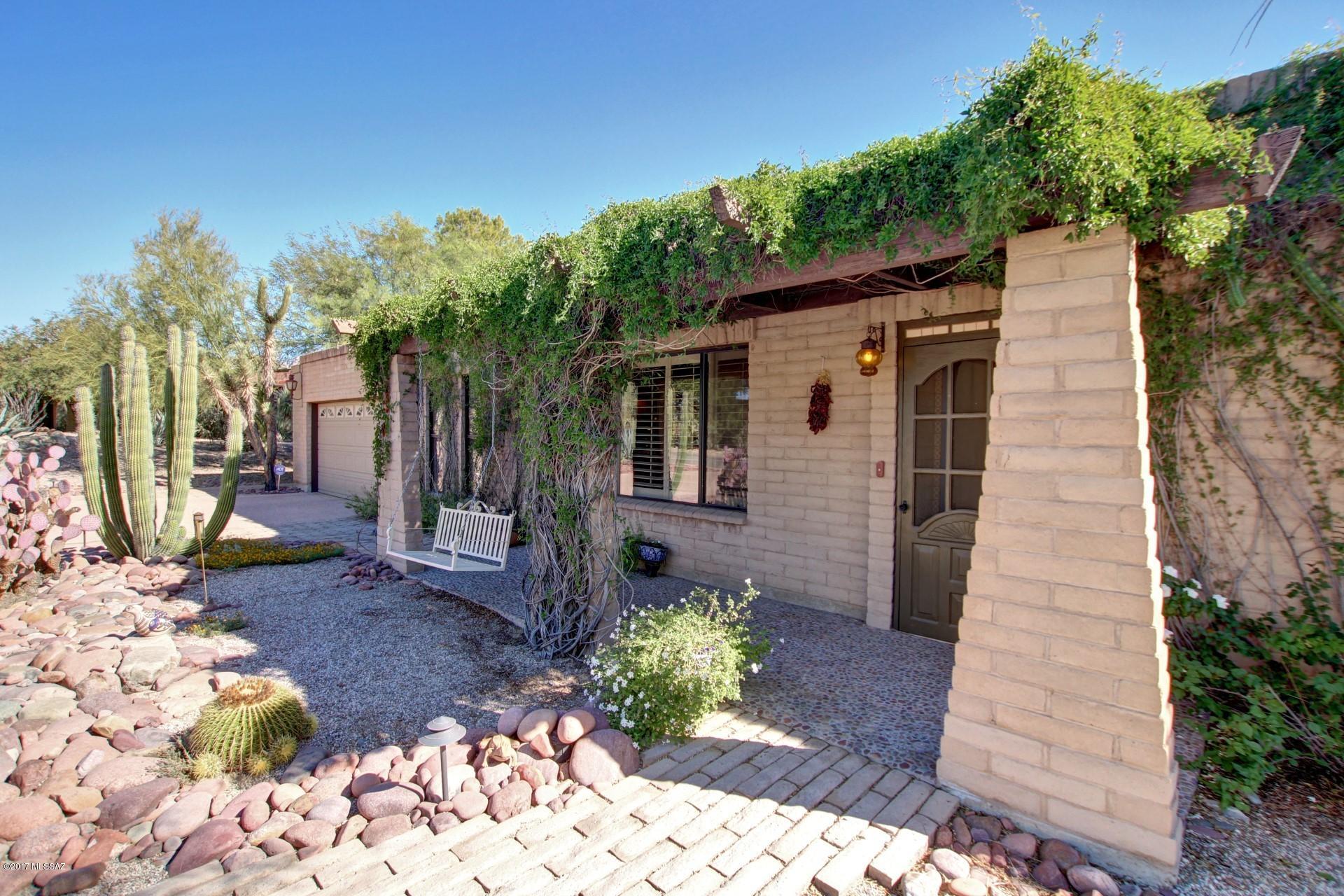 Beautiful & well-cared for slump block construction featuring hard wood & ceramic tile flooring throughout, two-tone paint, updated kitchen with corian counters, gas stove & stainless steel appliances. Home also boasts solid wood doors throughout, energy efficient windows & plantation shutters. Beautiful landscaping in front & back yards, spacious covered front & rear patios with a pepple-tec pool. Relax & enjoy the large, private yard. Home also features a 2 car garage with built-in storage cabinets & workshop plus a large interior laundry room. Lovely home that is move-in ready for the new owners.