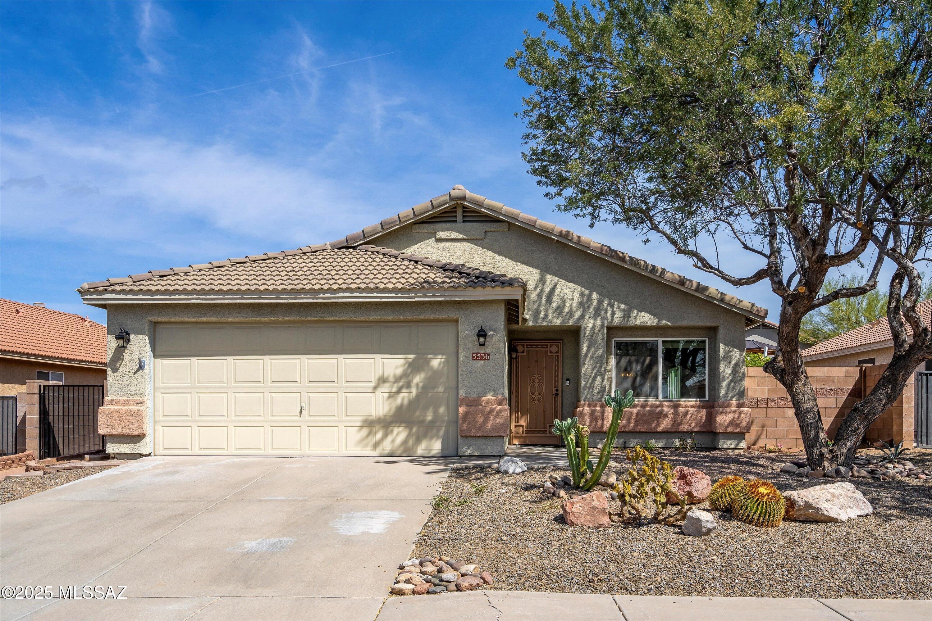 Charming 3BD/2BA (1495 sq ft) home located in Qual Crossing at Dove Mountain.  Upon entry you will find soaring ceilings with open concept floor plan. All tile (no carpet) and interior freshly painted. Chef's kitchen hosts, sleek appliances, nice pantry, ample counter tops and cabinetry,   Lovely family room with cozy gas fireplace and patio access.   Spacious owner's suite showcases private patio access, ensuite with double vanities, shower/tub and walk-in closet.  Two guest rooms with full hall bath. Retreat to your covered patio and backyard.  This gem is located close to hiking, biking, golf, parks, schools and restaurants. Only 10 minute drive to Interstate 10.  Truly a Must See!
