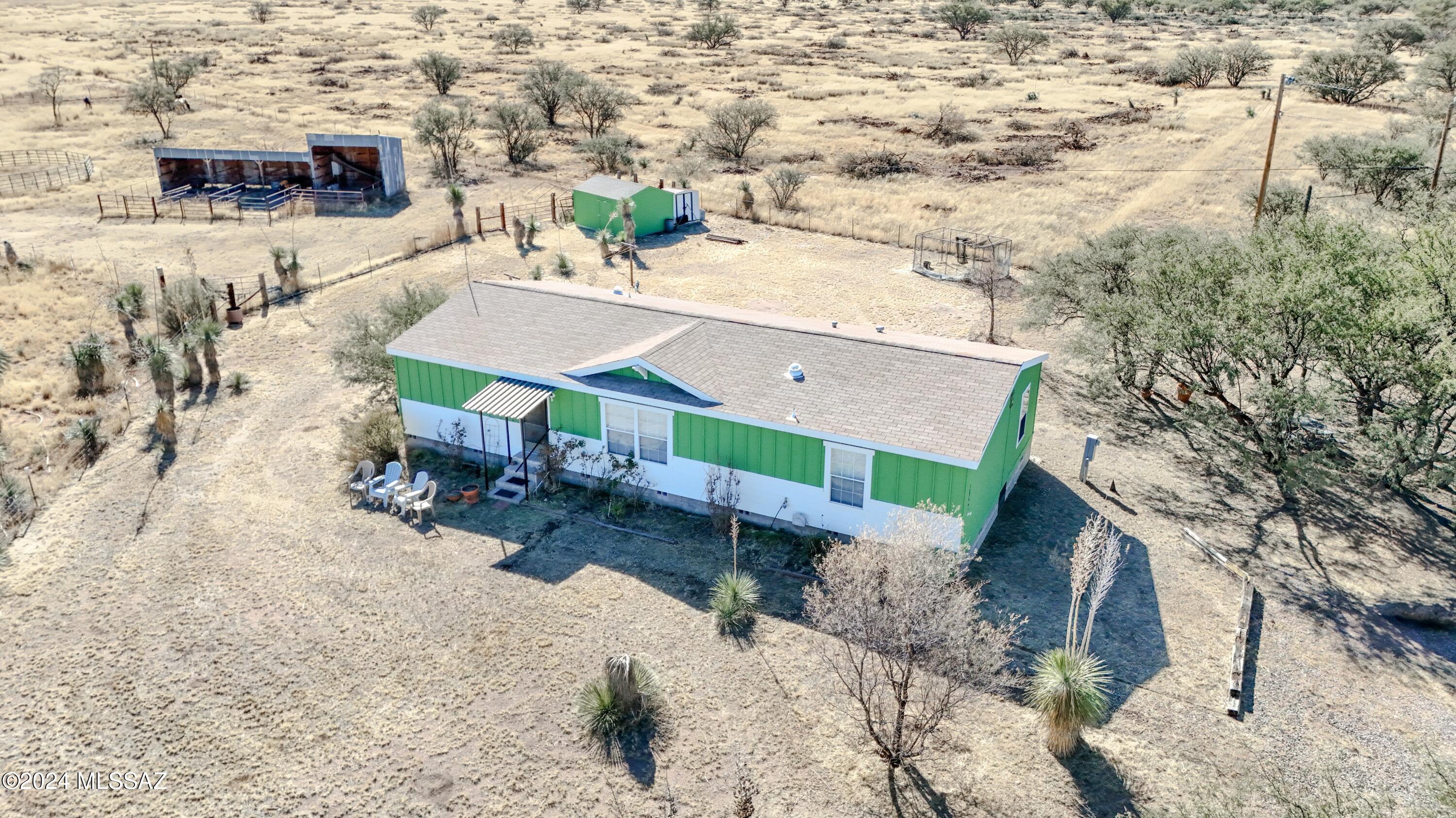This exceptional property, located just north of Sonoita, offers stunning mountain views and a peaceful retreat ideal for nature lovers and equestrian enthusiasts. It provides direct access to expansive public lands and is adjacent to the historic Empire Ranch and Las Cienegas National Conservation Area, a 45,000-acre haven for wildlife and birdwatching. The home features an open floor plan with a cozy eat-in kitchen and a master suite that includes a luxurious bathroom and spacious walk-in closet. Additional amenities include a dedicated laundry room, fully fenced and cross-fenced areas for safety, a large livestock walk-in, a tack room, and a storage shed. A fenced garden area is perfect for gardening enthusiasts.