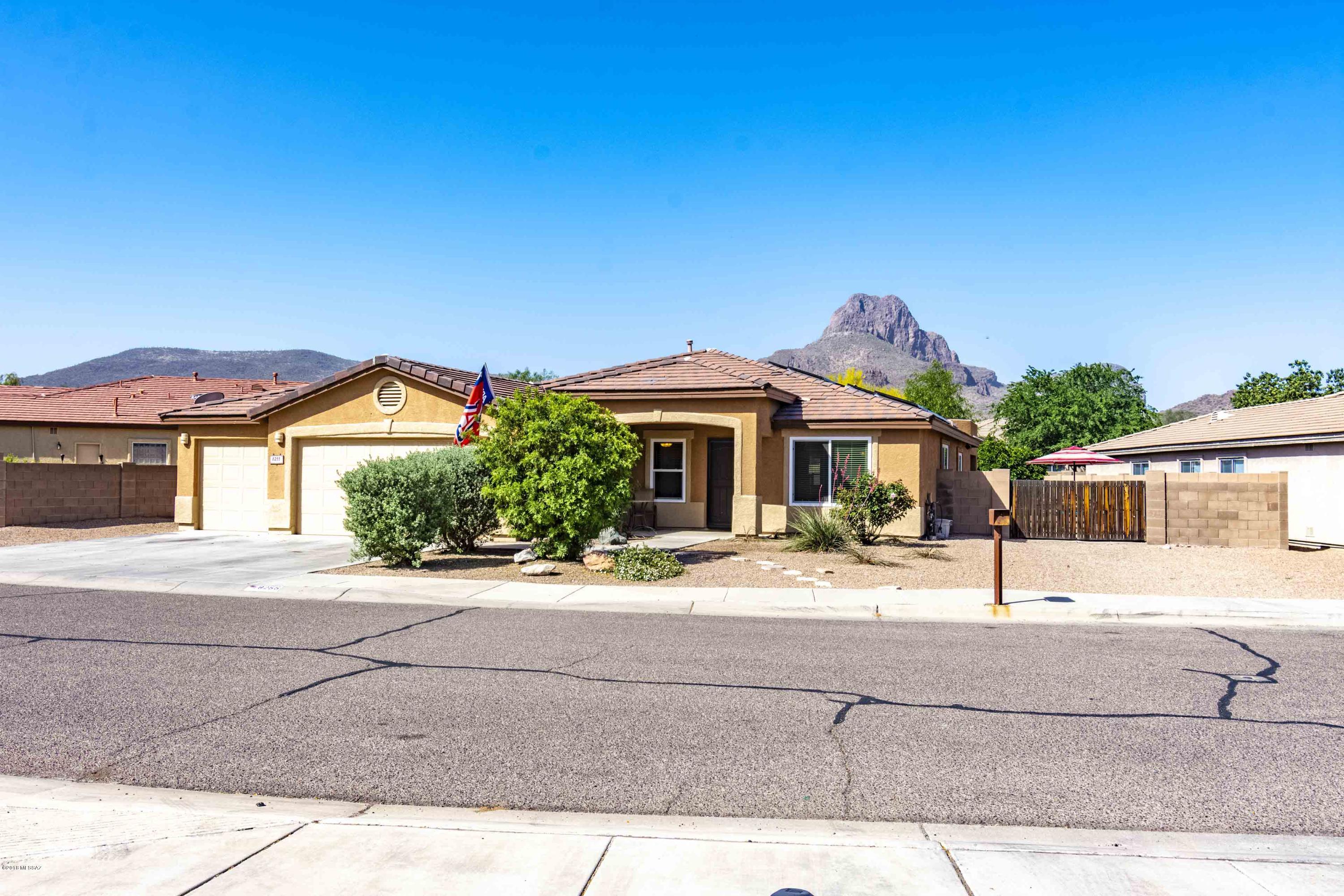 Gorgeous rustic-modern home on larger lot!  WELCOME HOME!! Updated tile flooring, counters, bathrooms -- open floor plan, lots of natural lighting.   Custom entertainment center with electric fireplace lends a contemporary touch.  Surround sound inside & out helps you feel at home.  Cook's kitchen adds tons of storage, island, pantry closet AND pantry cupboards.  Your back yard is terrific for entertaining with pebble tech pool and waterfall, mountain view,  flagstone pavers, double gate access, large covered patio and kitchen island with gas grill. Solar Lease with Solar City. Three car garage with shelving. Close to schools, parks, and easy freeway access. Move in ready .