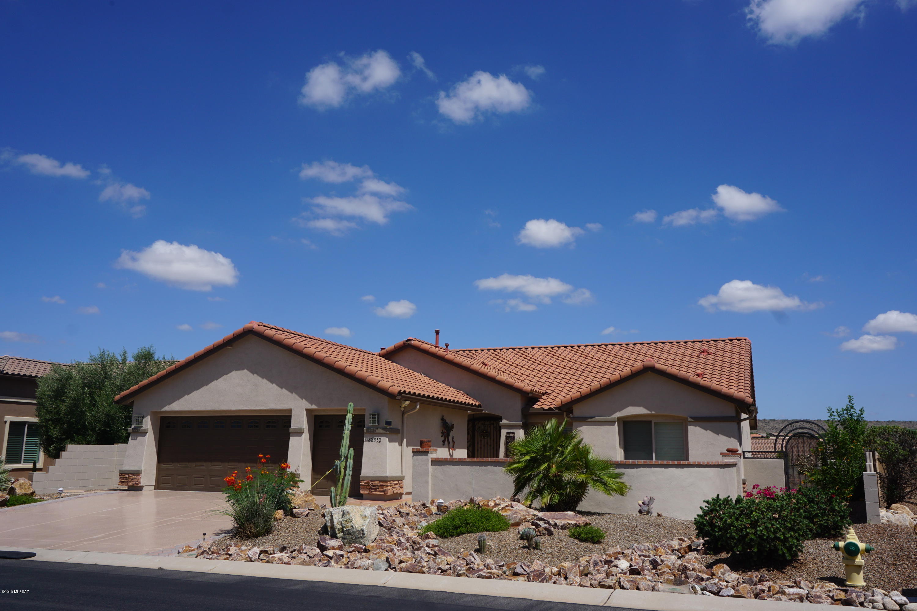 The media wall is down and we are back on the market. This Montana Model now has the much sought after open concept that many were asking for. This home offers over 2200 Sq Ft of living area, granite counters in the kitchen, quartz counters in both bathrooms, plantation shutters throughout, tile and carpet floors, a 2-1/2 car extended garage w/extra storage, an epoxy coated back patio, front courtyard, garage floor, & driveway, a large elevated lot with backyard privacy & gorgeous sunset views looking out to the Tortolita Mountain Range on one side & the Santa Catalina Mountains on the other. This home also includes low care front & back yard landscaping, a fully walled & gated backyard, a den that looks out over the front courtyard (see Supplemental for more info) and offers a spectacular view of the Santa Catalina Mountains, zoned heating & cooling, a large aluminum Ramada covering a portion of the back patio, a large patio that has been extended with brick pavers to form walkways to a water fountain and an island for the gas fire pit, a hot water recirculating pump, and a whole house water purification system offering water from each faucet that resembles bottled water. All designed to make this home very easy to maintain.