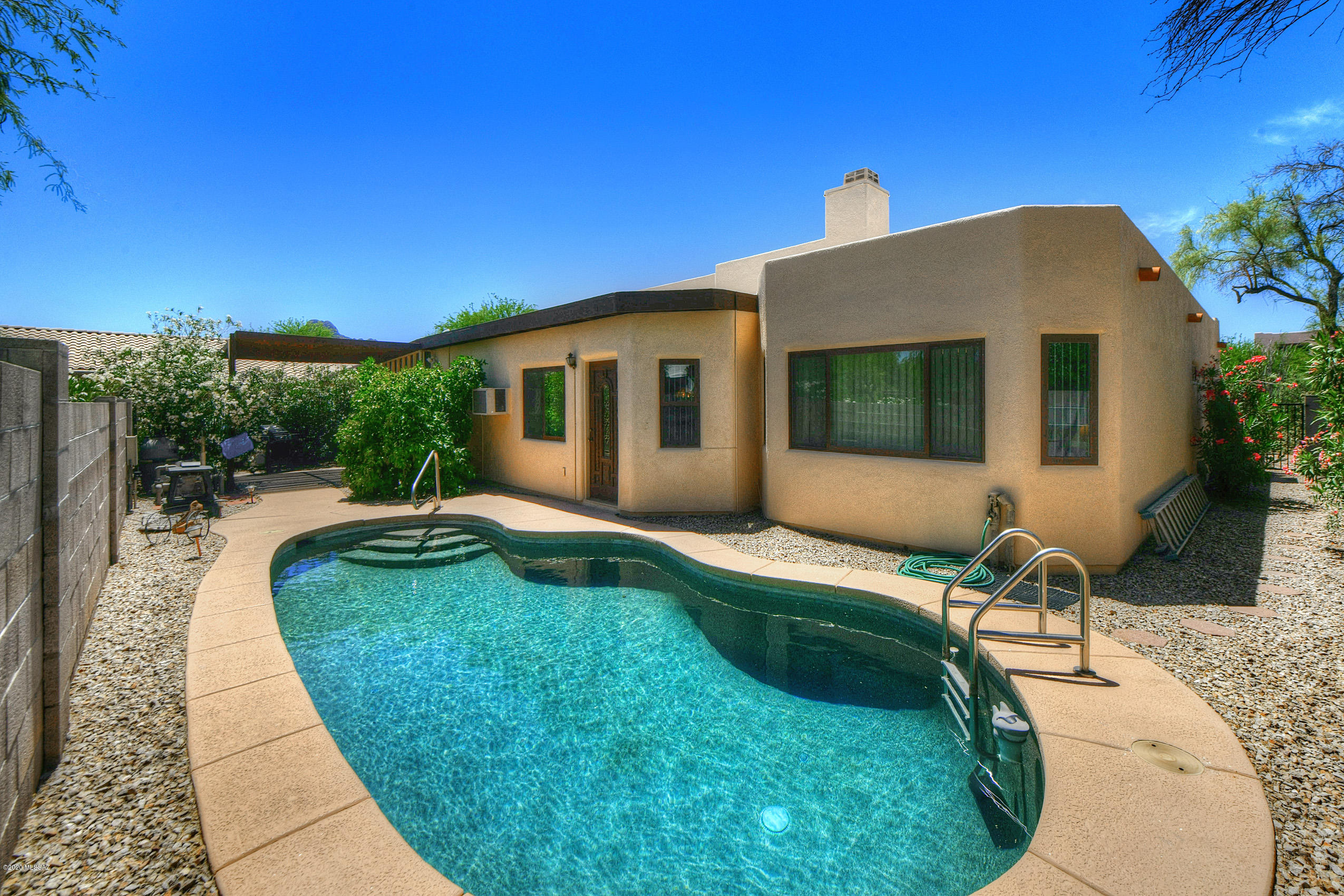 Beautiful Sante Fe Style home in desirable Continental Ranch community. This home is move in ready and full of upgrades! Step through the new front door to see the gorgeous high ceilings with exposed beams and beehive fireplace. Stainless steel appliances in the kitchen along with new faucets and shutoffs throughout home. The bathrooms have been tastefully remodeled with Italian Marble showers and new toilets. Relax outside in a private Arizona room with Spa, or take a swim in the refreshing pool,which has a new cleaning system and pump. Enjoy amazing sunsets and mountain views from the front courtyard. The list of upgrades continues with fresh exterior paint and roof coating, new water heater, new garbage disposal, new Anderson windows, extra long driveway, new garage door & much more!