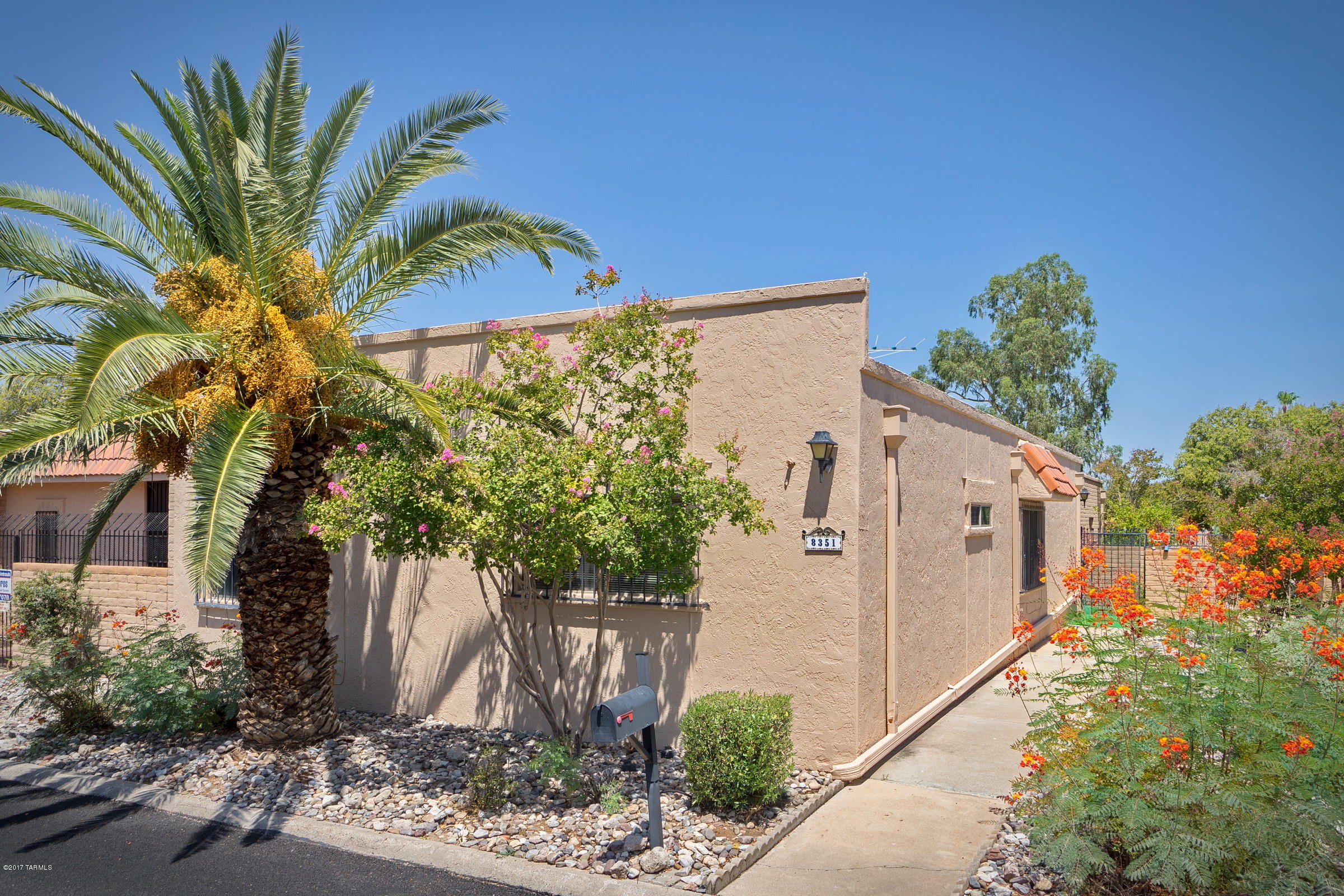 Rare 3 bedroom Townhouse in this high demand neighborhood next to the Rolling Hills Golf Course! Sun screened courtyard entry and citrus producing trees welcomes you to your move-in ready home. Just painted throughout with plenty of storage in the 2 car masonry construction garage. Pool, children's pool and spa a block away with a great HOA in a safe neighborhood. All appliances stay including 2nd 'fridge' in the garage! Quiet & private. RV Parking available! There are 2 Ownership Certificates being offered by the Sellers to Rolling Hills Golf Course that may be included with the sale of this property.