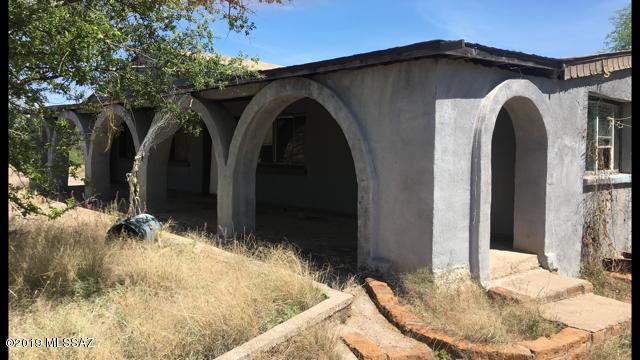 This property sits right off Paved Road with Great Access.  4.55 Acres and room for so much improvement.  Well , Sewer and Electric gives you a great start to either take the existing structures and rebuild , or tear down and build the home of your dreams.  Room for nice horse arena as well.   Super Snow bird fixer upper in a great community.