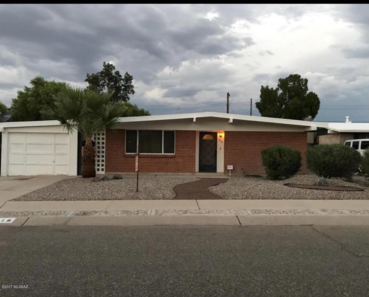 You will love this quiet cozy 3 bed 2 bath brick home, low maintenance front yard and a spacious backyard. This home has a beautiful open kitchen, a den with built in office space and a one car garage. AC, new windows tiled countertops, appliances and washer/dryer included, great area located near the Tucson Mall and Flowing Wells school district.