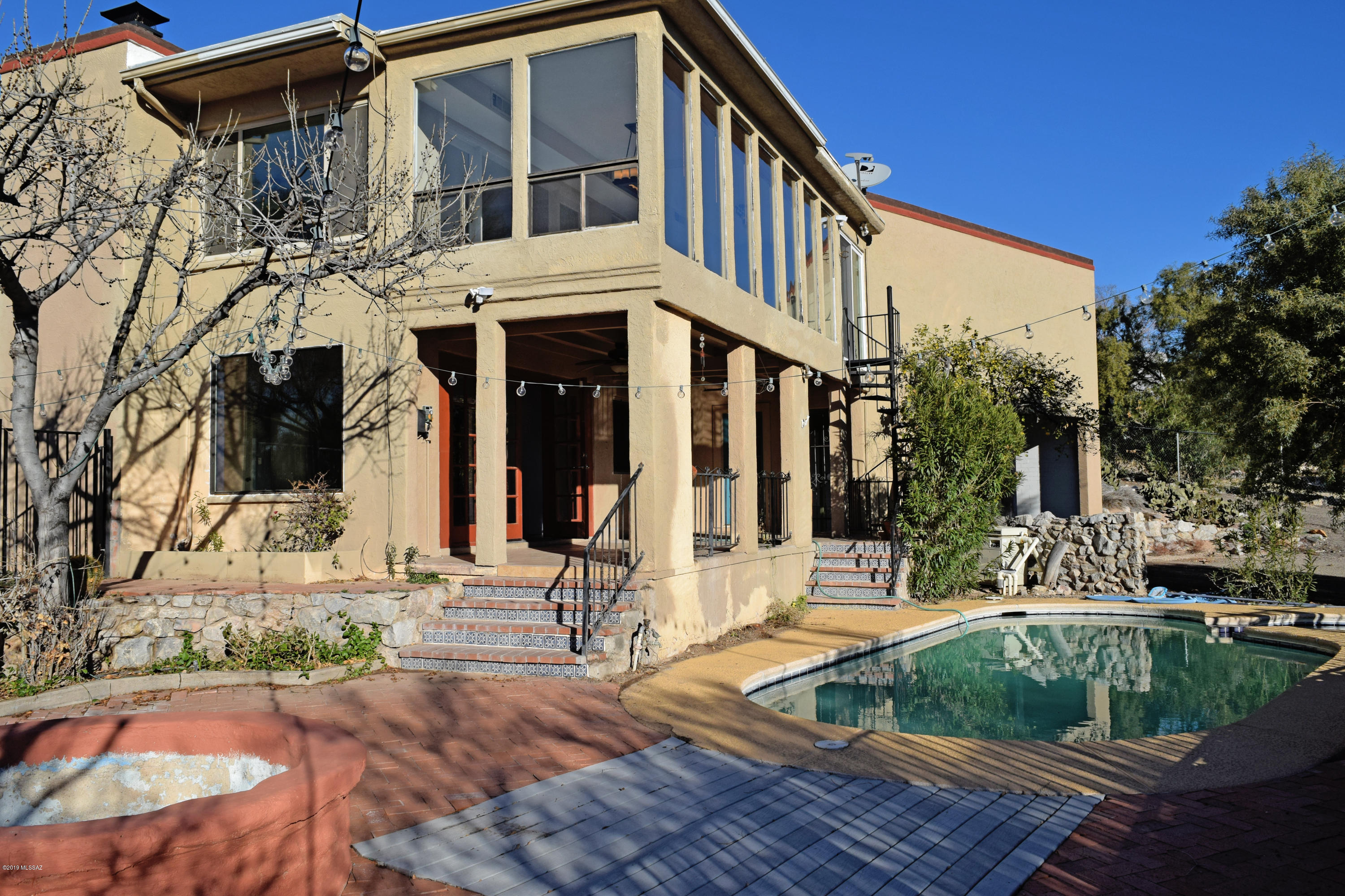 This immaculate estate truly has it all! This home embraces an elegant formal dining room with a lovely picture window and indoor copper grill, a soothing fireplace in the living room and one in the family room, a 2 car garage, an extended double carport perfect for bonus parking, boat storage, a workshop and includes a 220 hookup for RV parking! Step out to the backyard and down the spiral staircase, and revel in the oasis like ambiance this home has to offer; displayed by the sparkling pool, tranquil spa, spectacular city and majestic mountain views! This property is an absolute MUST see!  Pool service included in rent.