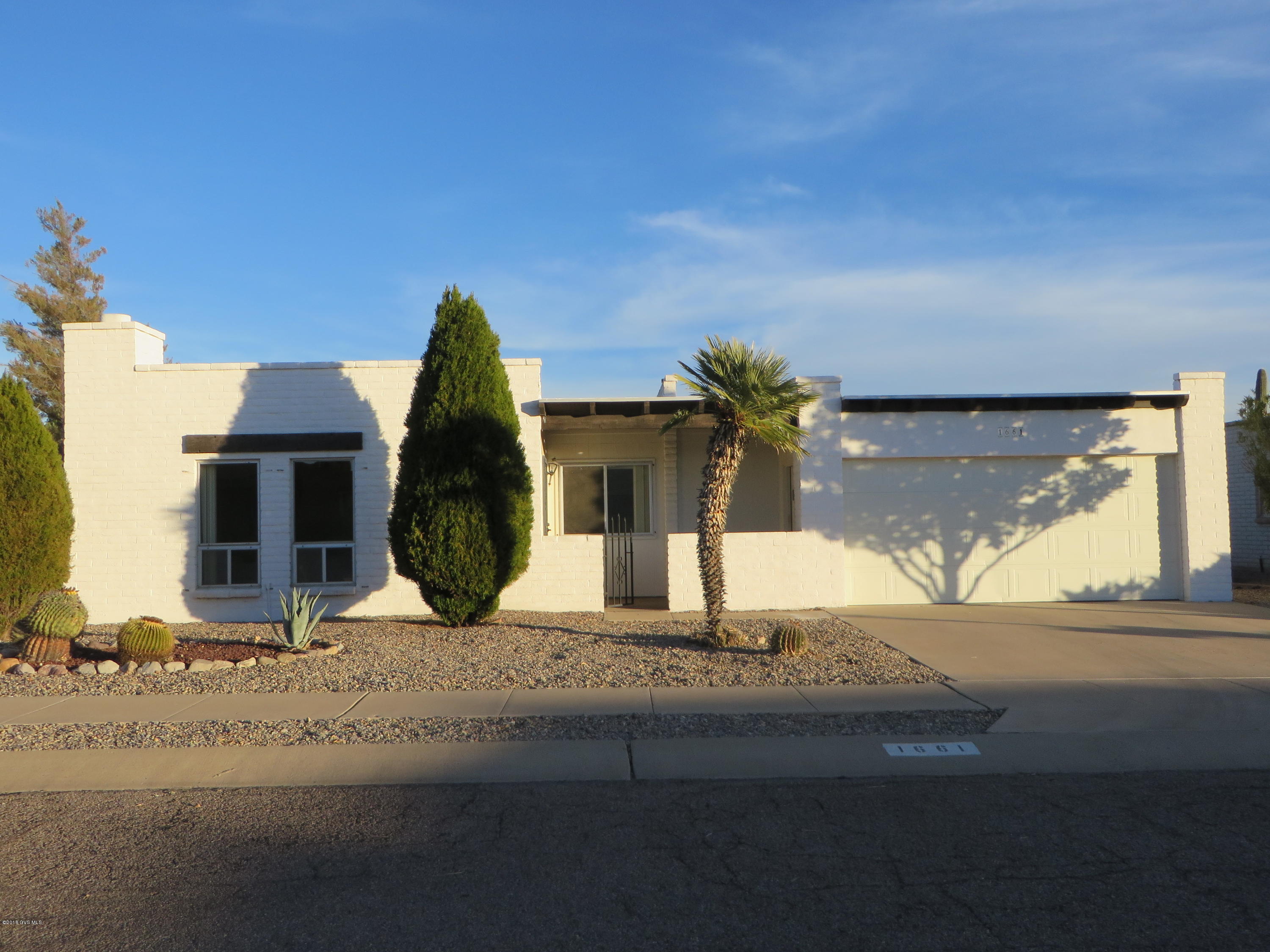 Nicely remodeled home with East facing walled back yard with mountain views. Inside appreciate the corner fireplace, a pass through kitchen to the dining area & remodeling/updating that includes new paint & carpet, bathrooms with new vanities/sinks/faucets & new light fixtures. Kitchen has freshly painted cabinets, new dishwasher, garbage disposal & range hood. The great floor plan flows well with a spacious dining area and large owners suite with walk in closet. Don't miss the desired oversized 2 car garage with work area, plus a separate laundry/storage rm. Relax and enjoy our fabulous Southern Arizona weather on the outdoor screened room while enjoying the Mt views. This home is part of GVR with all the amenities GVR offers plus is located only a block from the GVR Abrego South center