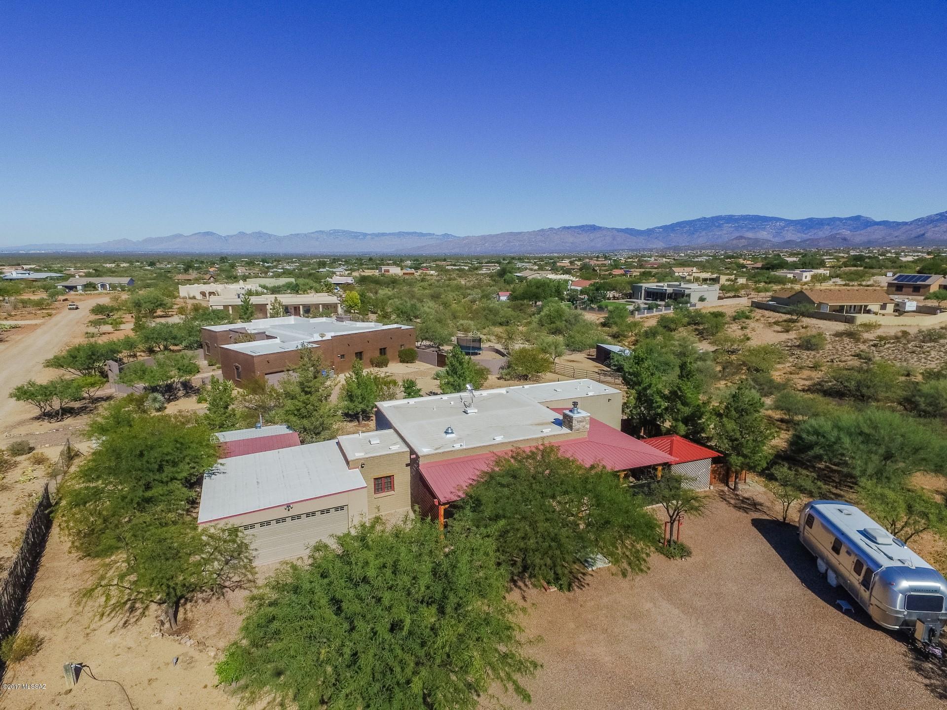 Seller to accept offer,cntr offers within the range of $299999-324999.Bring your visions to life! Custom Mud Adobe energy efficient home,vigas in almost every room,ceiling fans, garbage disposal, dishwasher,new appliances,new hot water heater wrap-around porch with red metal roofing, 2 energy efficient air conditioners/heat pumps, solid & quality built home, Marvin windows throughout home, steel door frames, gazebo with metal roof, acre completely fenced, additional redwood fenced yard, lots of trees, fully landscaped, lots of room for RV parking, complete sprinkler system Gorgeous Vail home on 1+ acres surrounded by pristine desert and majestic mountain views! Enjoy all of life's modern luxuries while relaxing in this rustic cowboy themed home!
