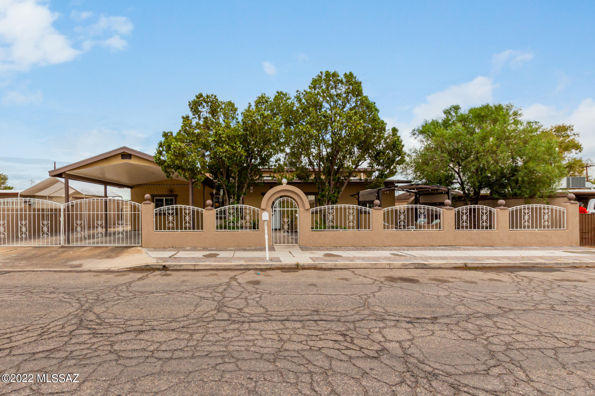 Welcome home! Fully-fenced 5 bedroom/2.5 bath home with private courtyard in South Tucson with NO HOA! This home features high ceilings, gorgeous wood-like ceramic flooring, recessed & pendant lighting, stone accent wall & a wine bar for your entertainment. Kitchen showcases wood cabinets w/crown molding, granite counters, a walk-in pantry, & large island with breakfast bar. Primary ensuite provides a walk-in closet and beautiful bath with designer tile. Backyard includes wrap-around exterior lighting, full-length covered patio, storage shed, workshop & charming tree house! Come take a look today!