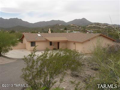 This 3 bedroom beauty offers a Lush & private desert setting on an acre lot & it's convenient to I-10, shopping, etc. Designer touches include tile & Pergo flooring, French doors to patio, crown molding throughout, 2-way fireplace in the living room & fam. room, eat-in breakfast nook, formal updated master bath, huge back yard & cov. porch, sports pool, extensive brick patio, built-in BBQ, huge garage & great views. Truly a must see. Tenant will contribute $75 a month for pool service.  Our lease terms, rental application requirements, and/or the pet policies for this rental. Please go to www.PimaRealEstateServices.com for more info or to submit a rental application