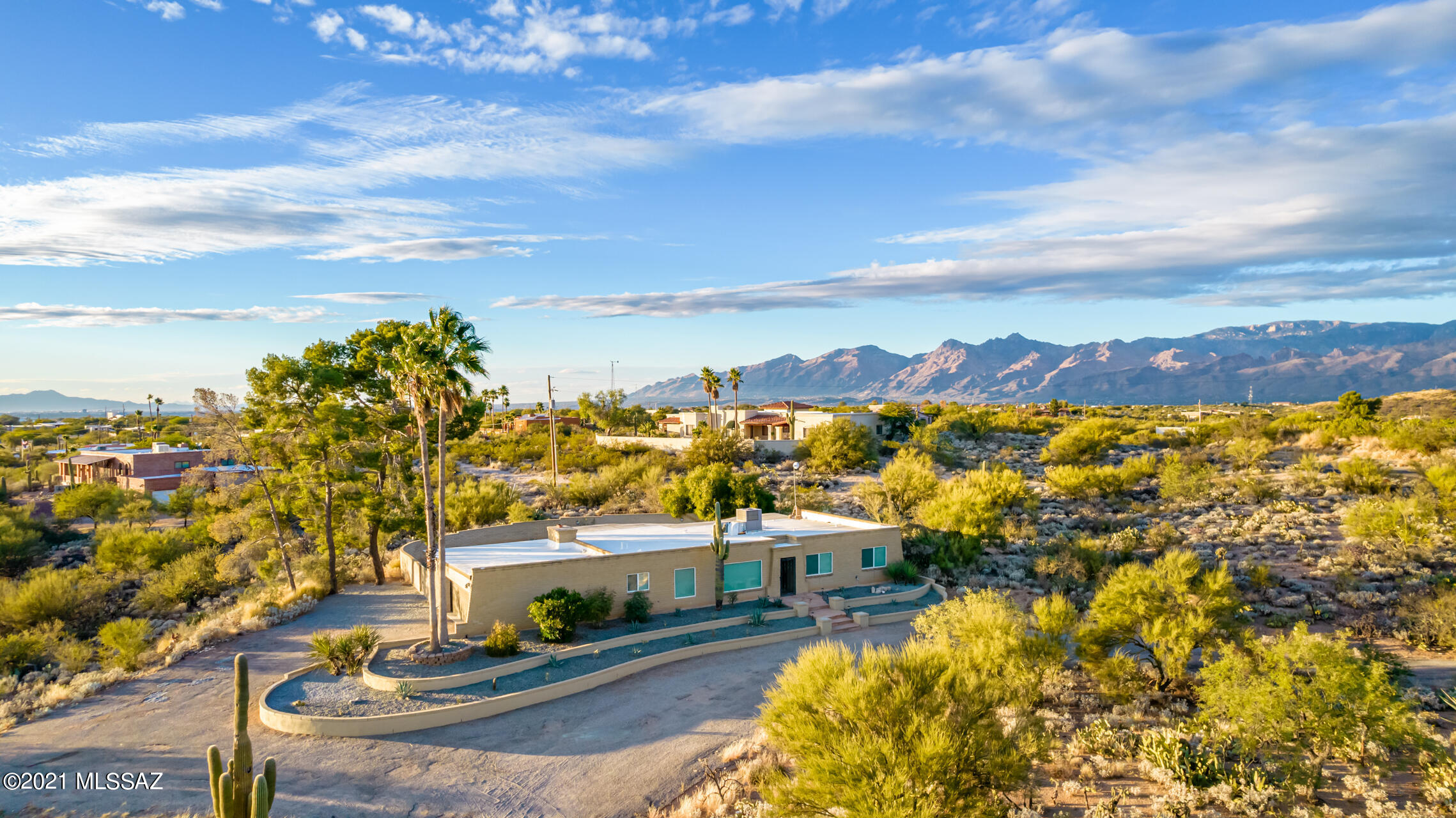 Be the proud owner of this outstanding estate on an elevated 3.26-acre lot with exquisite view of the White Tank Mountains! This property features spacious 3 car garage, circular driveway, pool, desert landscape, and it's only a 5-minute drive from Saguaro National Monument East. Discover the open floor plan showcasing tile floors, recessed lighting, neutral palette, & inviting fireplace. The remodeled kitchen offers ample wood cabinetry, stainless appliances, granite counters, a pantry, and center island with breakfast bar. The large primary bedroom boasts, a walk-in closet, pristine bathroom, and private door to the backyard. Host fun gatherings in this delightful backyard with a pool and oversized covered patio with lovely pergola. Vast area great for horses!