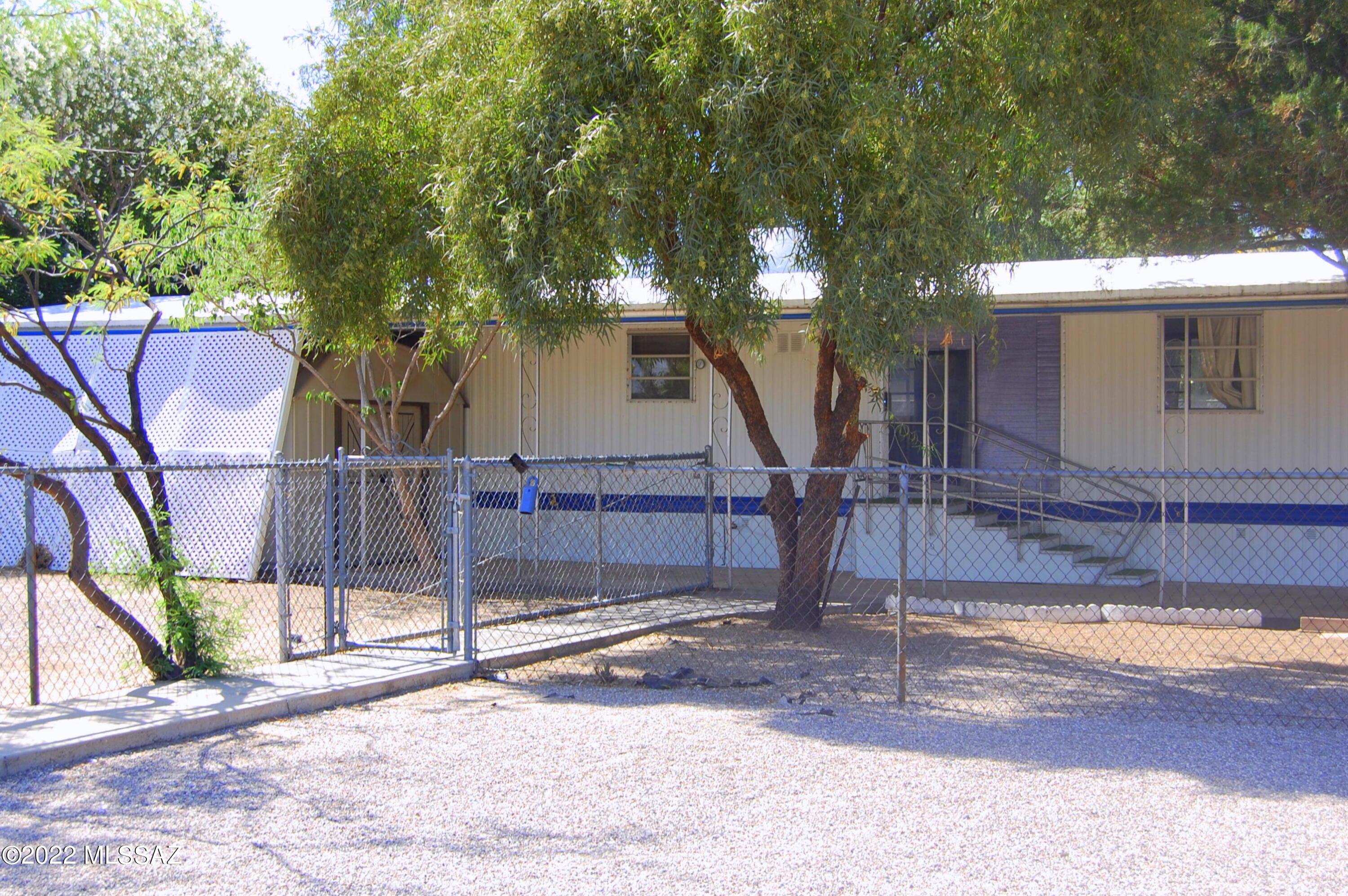 AS-IS Trust Sale No Warranties Expressed Or Implied. Large Lot with double gate upfront and lots of storage sheds, plenty of room for your stuff. Large one bedroom one bath home. Large Living room and big enclosed patio/Arizona room. Enclosed laundry room and nice shop area all attached to the mobile home. Pet sanctuary that is enclosed and attached to the house. One car carport on the other side so that it is not in the way. Close to Bus Line and EZ access to I-10.
