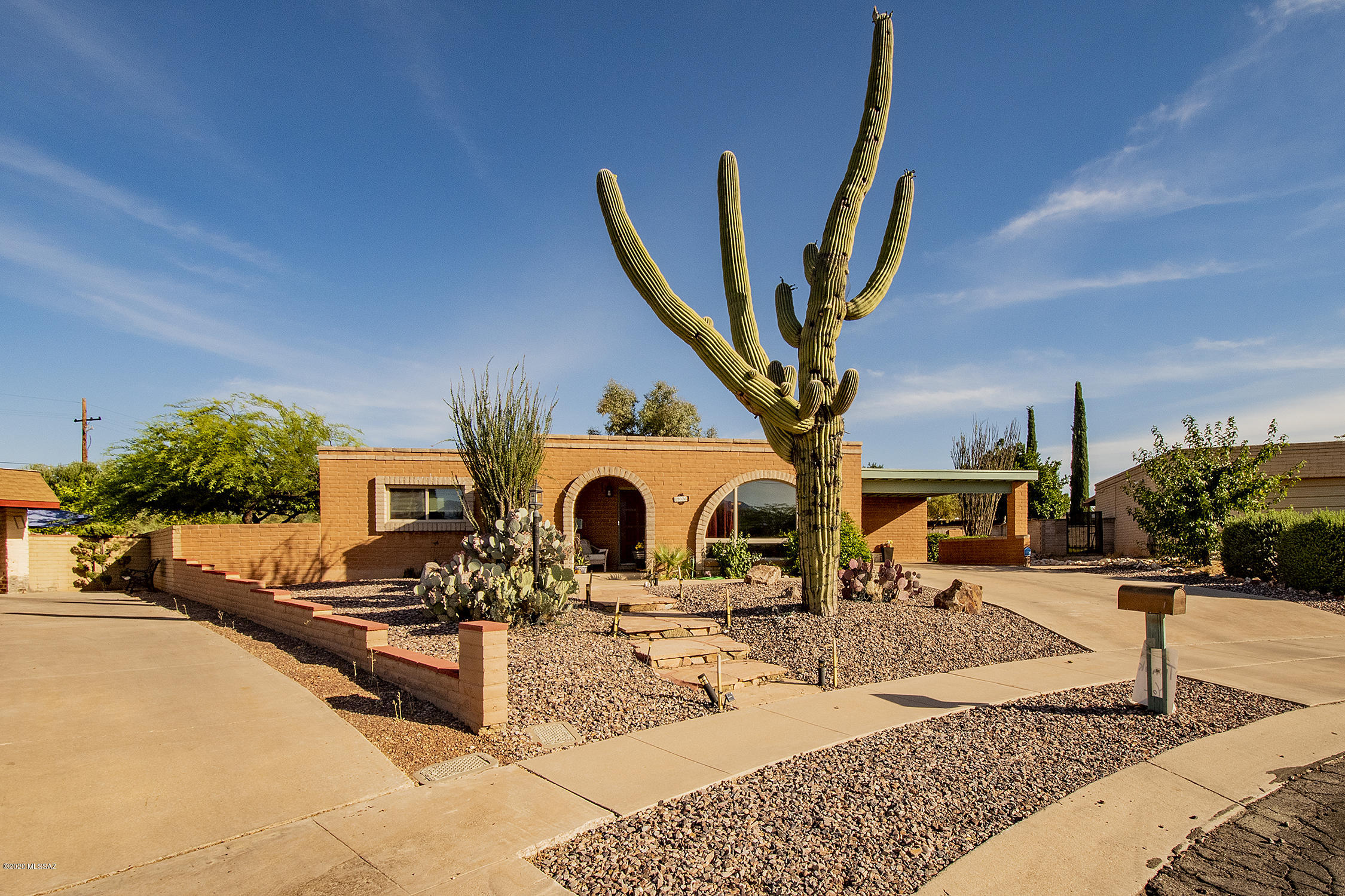 Come and see this beautifully maintained brick home featuring 4 bedrooms and 2 baths on a cul-de-sac street. Flagstone steps lead you up a beautiful desert landscaped yard, an absolutely gorgeous large Saguaro, and a front sitting area where you can enjoy amazing mountain views! Walk in to a formal living and dining area with lots of natural light and spectacular picturesque view of the Catalina's from your front window. The kitchen features black/stainless steel appliances, updated cabinets, and beautiful Corian countertops. Off the kitchen is a family room with wood burning fireplace and an eat-in area. The backyard features a large covered patio, extended pavers, beautiful water fountain, plants and mature trees. Hard to find a yard this big! Come and see it today!