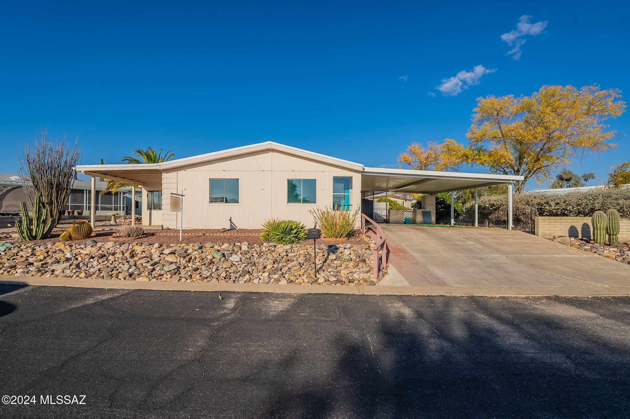 NEW NEUTRAL INTERIOR PAINT! On a high lot with mountain views east & south, this 2 bed/2 bath has an open floor plan, double covered carport plus 2nd driveway, 18'x10' workshop, 2nd patio and huge storage shed. The living/dining room with vaulted ceilings opens to the 9'x18' sun room for an extra 162 sq. ft. not included in the sq. ft. New flooring in the  Great Room is wood-look luxury vinyl. New bedroom carpet. More storage in the laundry room with washer/dryer included. The kitchen features newer stainless appliances, gas range, and breakfast bar. In the primary suite, you'll find a walk-in closet, bathroom with large shower, and double vanities. There's also a walk-in closet in the guest room. You'll be amazed at the options you have in this large, spacious home! No GVR. The 162 sq. ft. enclosed AZ Room is NOT included in sq. ft. The total is 1,722! Roof Warranty to 2026; GV Cooling & Heating maintenance contract for 2025; Service Line Warranties paid for both water & sewer; termite warranty for 2025. All transferable.