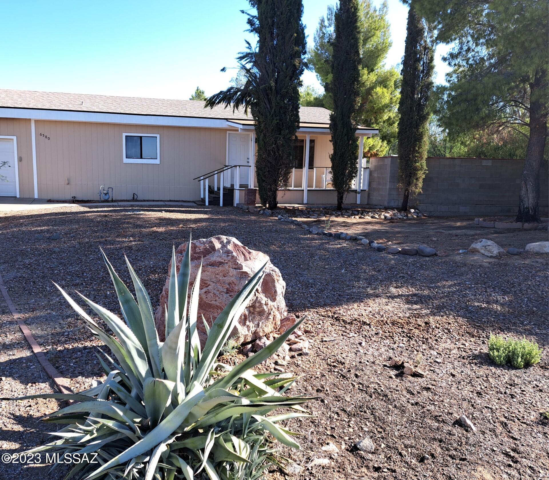 This updated 2 bedroom 2 bath home sits on just under a half an acre!  Huge great room with beautiful views.  Bedrooms have new carpet.  New wood laminate.  Huge kitchen with a large island. Plenty of storage. Truly a great place to entertain.  The additional room can be used as an office or den and has built in storage.  Covered patio in the front and a patio in the back off of the kitchen as well.  Part of the fence is brick and the rest is chain link.  The attached 2 car garage has 2 storage closets with built in shelves and one has the water heater.  The workshop is huge!  This is a must see home and is in pristine condition.  No HOA!!