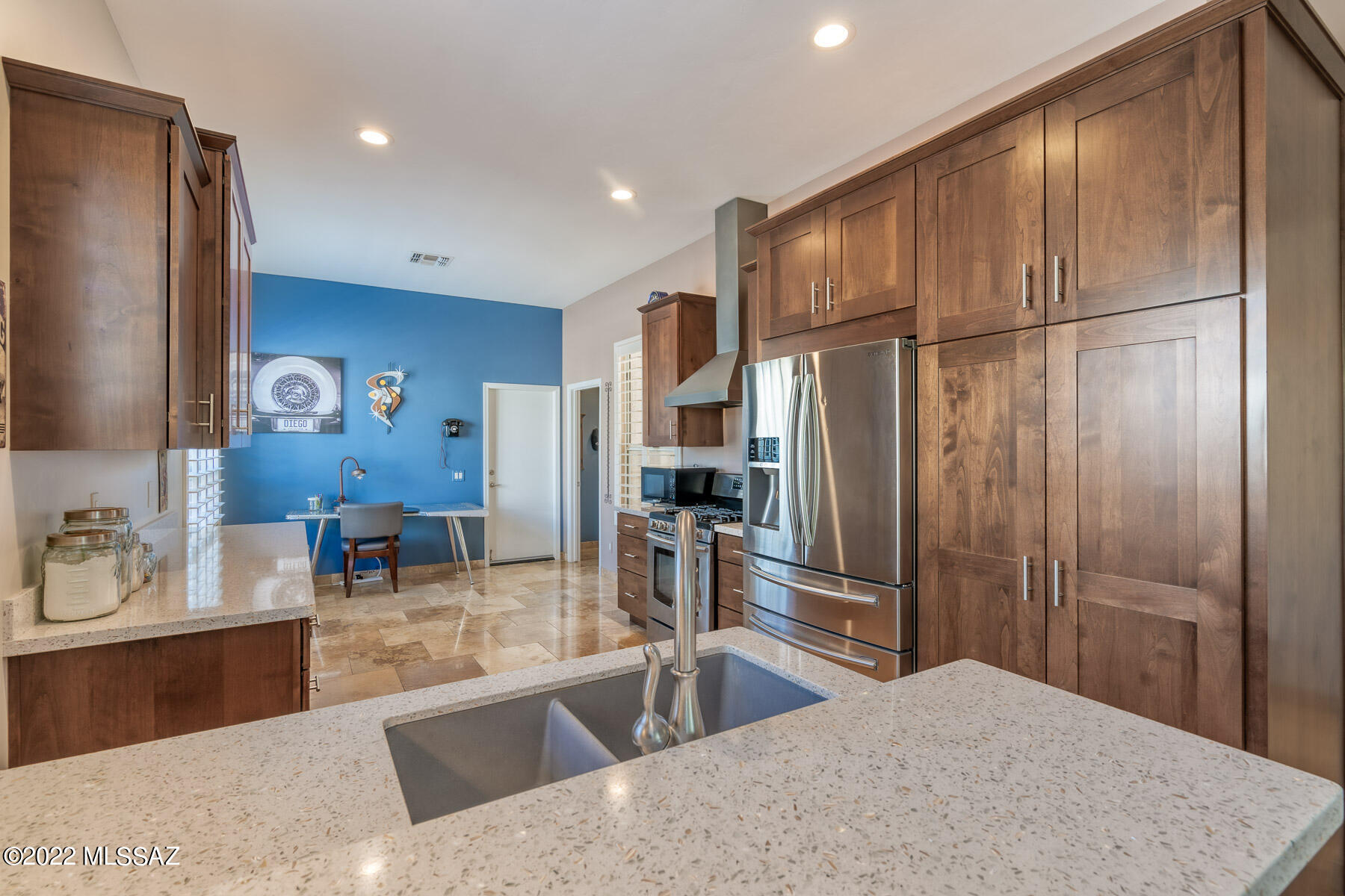 Beautifully and thoughtfully executed 2015 re-do of this SAN REMO Villa. High-end Decora alderwood cabinets w/pull-outs throughout. Quartz countertops. Blanco double sink. Stainless appliances w/5-burner gas cooktop & stainless hood, vented to outside! Travertine (both floors & baseboards) everywhere except carpet in the 2 BRs. Upgraded fans & lighting. Hunter Douglas window treatments. Back covered Patio is extended with pavers & was fully screened-in, 2021. Sunscreens on front & rear windows. Gutters. Door added to Primary Bath for privacy. Higher-height Toto toilets. Built-in storage added atop guest closet. Lovely, private-feeling backyard with no neighbors behind! Exterior painted 2020. Double-insulated Garage door . . . a fabulous SaddleBrooke Villa find!