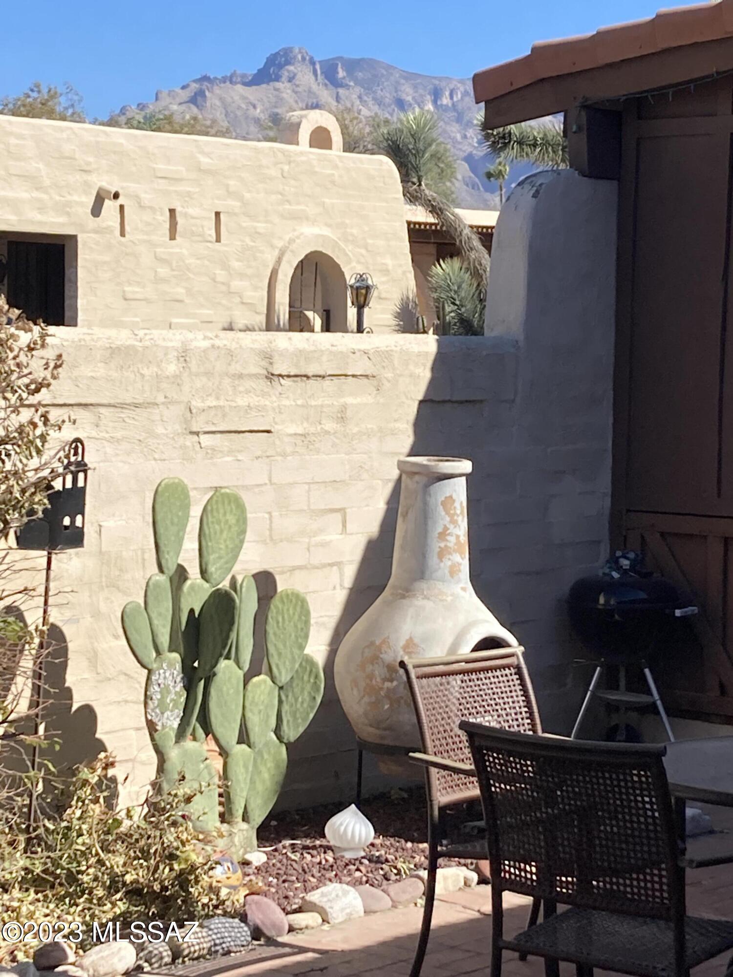 Cute townhome in desirable Pueblo Villas! Two bedroom two bath home with carport (HOA allows garage doors if desired) . Back yard has mountain view, and enjoy fresh oranges from your own tree! Stainless steel kitchen appliances and Bosch washer & dryer are included. Wood laminate and tile flooring throughout. Community pool, spa and clubhouse are close by. No rentals allowed.