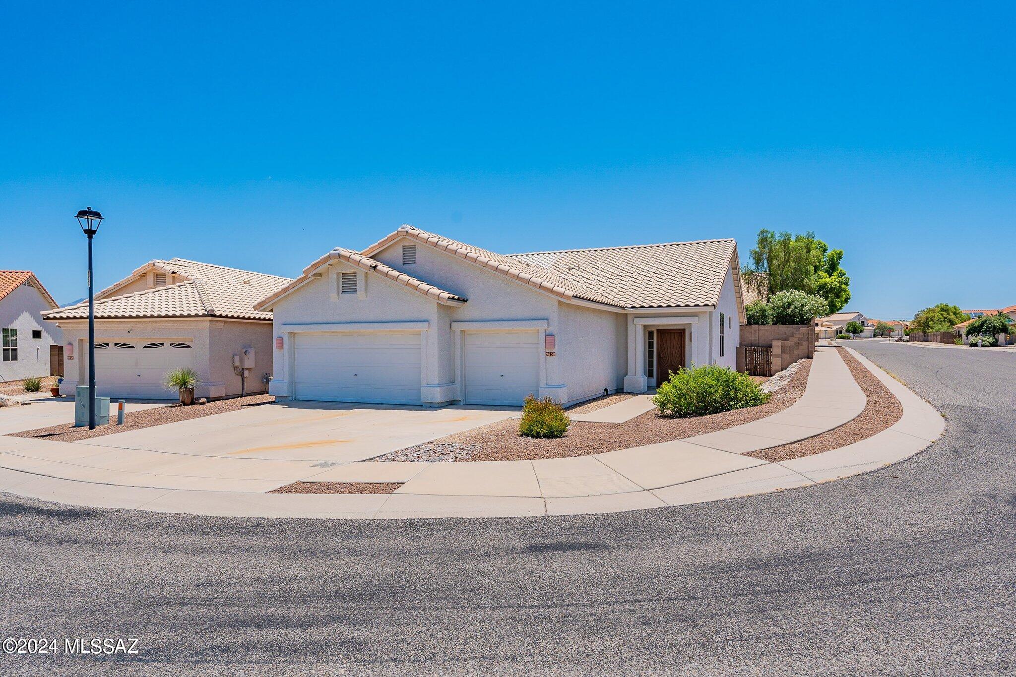 This home has a 3 CAR GARAGE, NEW TILE ROOF IN 2019 and NEW HVAC'S IN 2019.  3 bedrooms, 2 baths with 18 inch tile in living and kitchen areas and bamboo flooring in the bedrooms. You'll love the vaulted ceilings!  Primary bedroom has soaking tub and separate shower, dual vanities and nice closet space. Washer, dryer and refrigerator will all stay for your convenience.  Open kitchen has stainless steel appliances, corian countertops, double sink and opens to the family room with large picture window.  Pristine backyard with covered patio and privacy.  Double pane windows throughout. 3 car garage has storage cabinets, workspace counter, soft water loop and 5 foot garage extension.